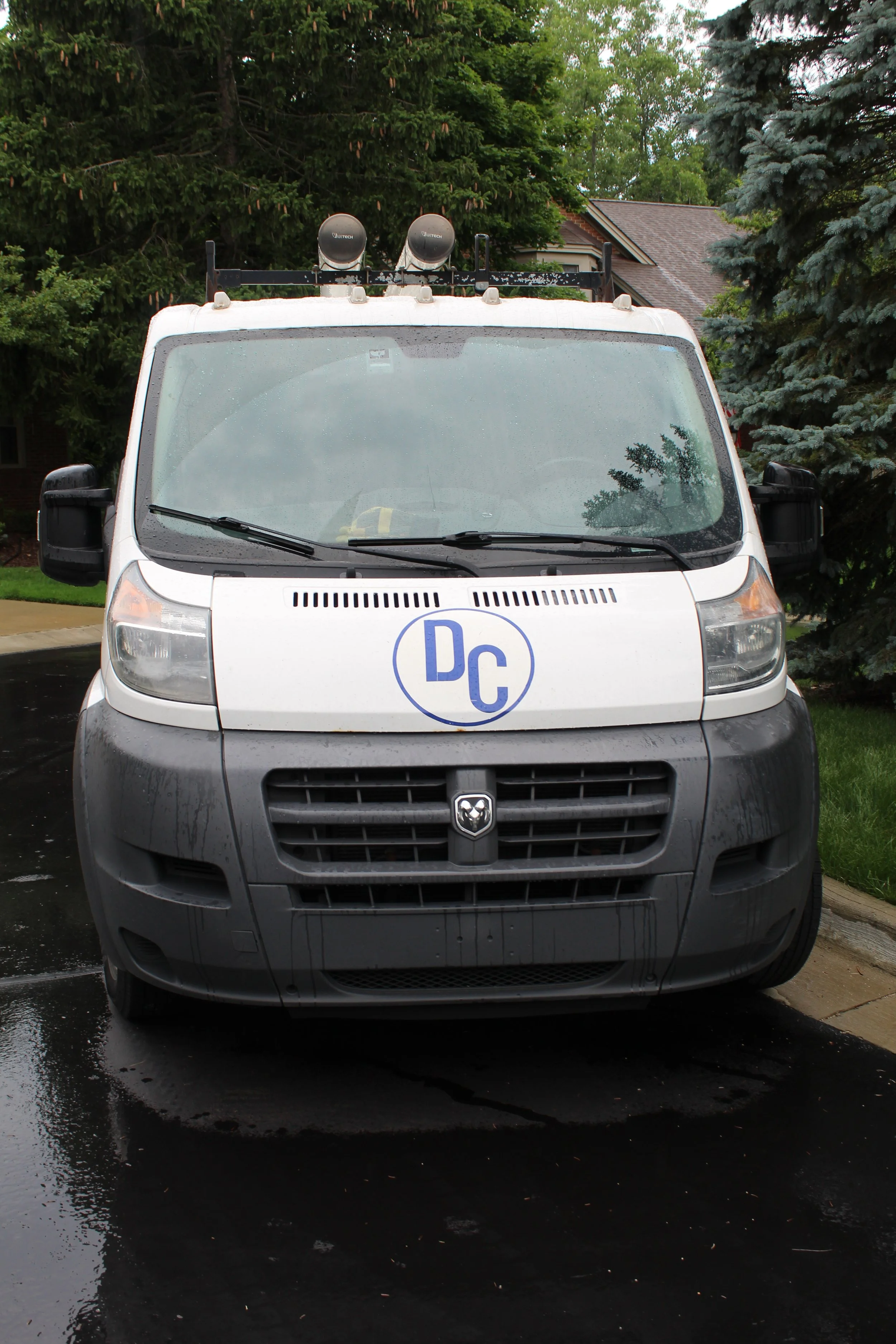 Front view of DC Dedicated Plumbing service vehicle with company logo.