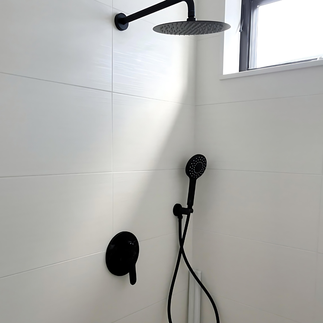 Modern shower fixture installation with black fixtures and tile by DC Dedicated Plumbing.