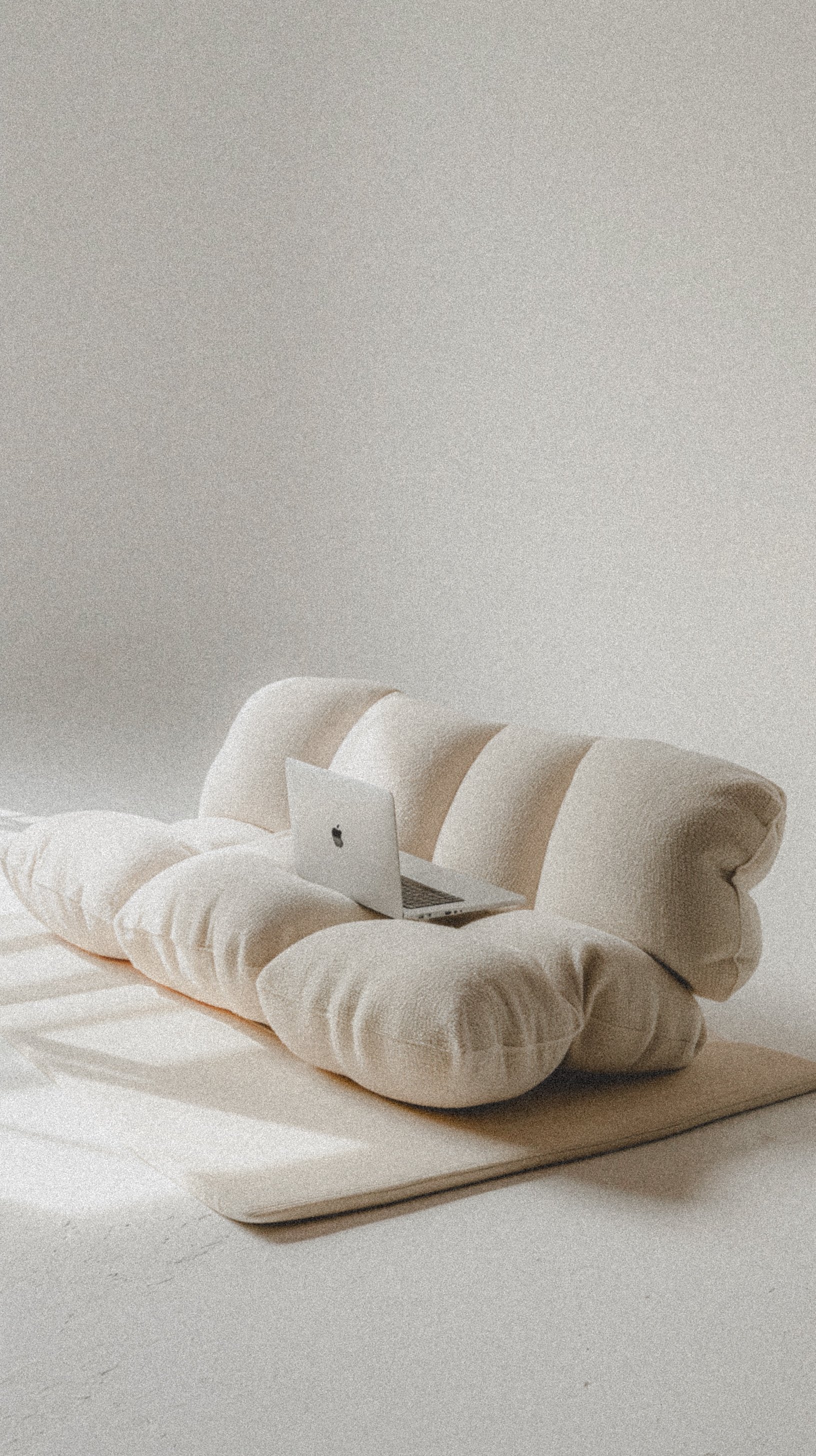 White couch with laptop sitting on top