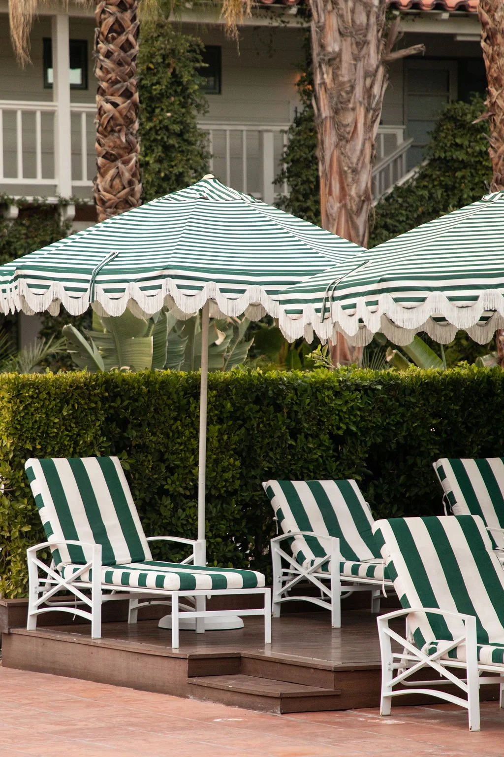green striped beach chairs and umbrellas