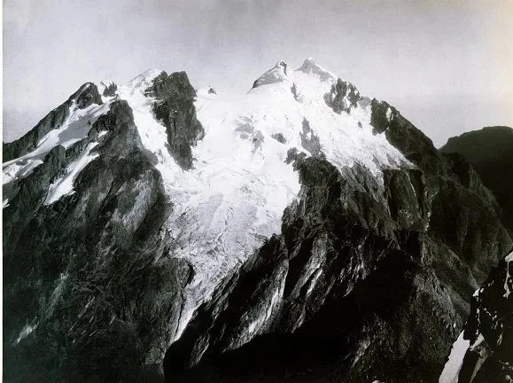 Snow-capped mountain with rugged, sharp rocks and glaciers.