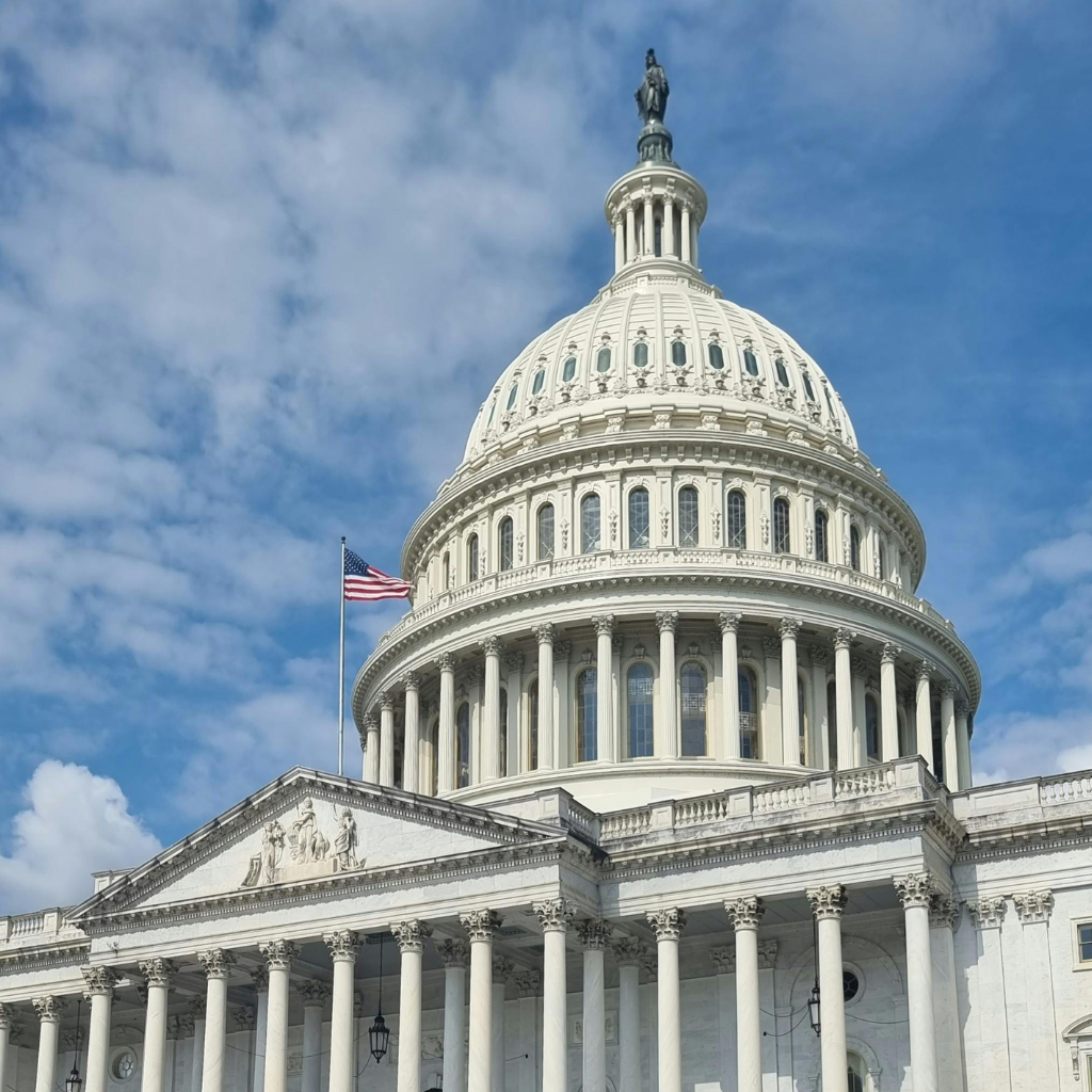 United States Capitol building under a partly cloudy sky.