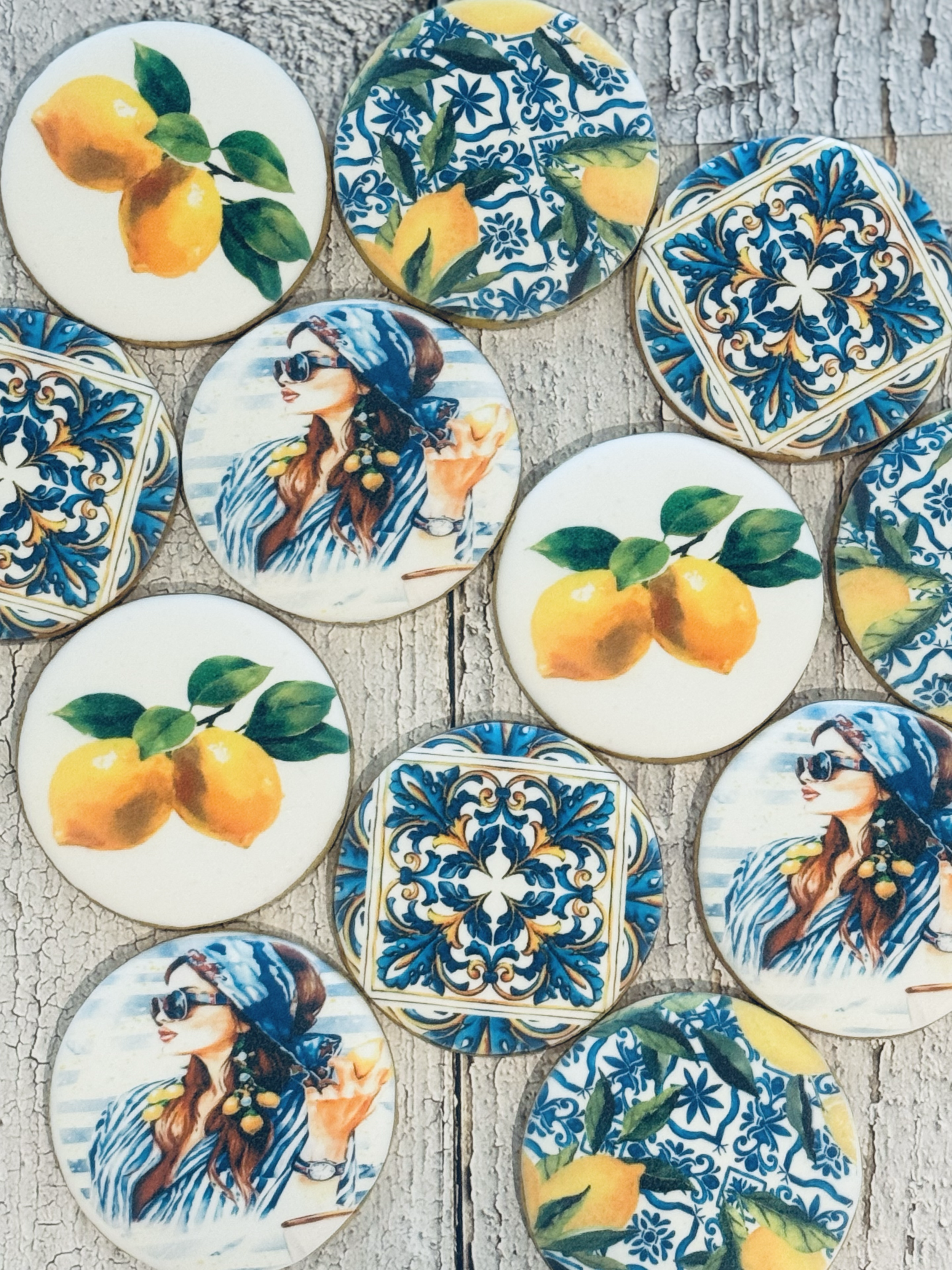 Decorative cookies with lemon, woman with sunglasses and headscarf, and intricate blue and gold tile patterns.