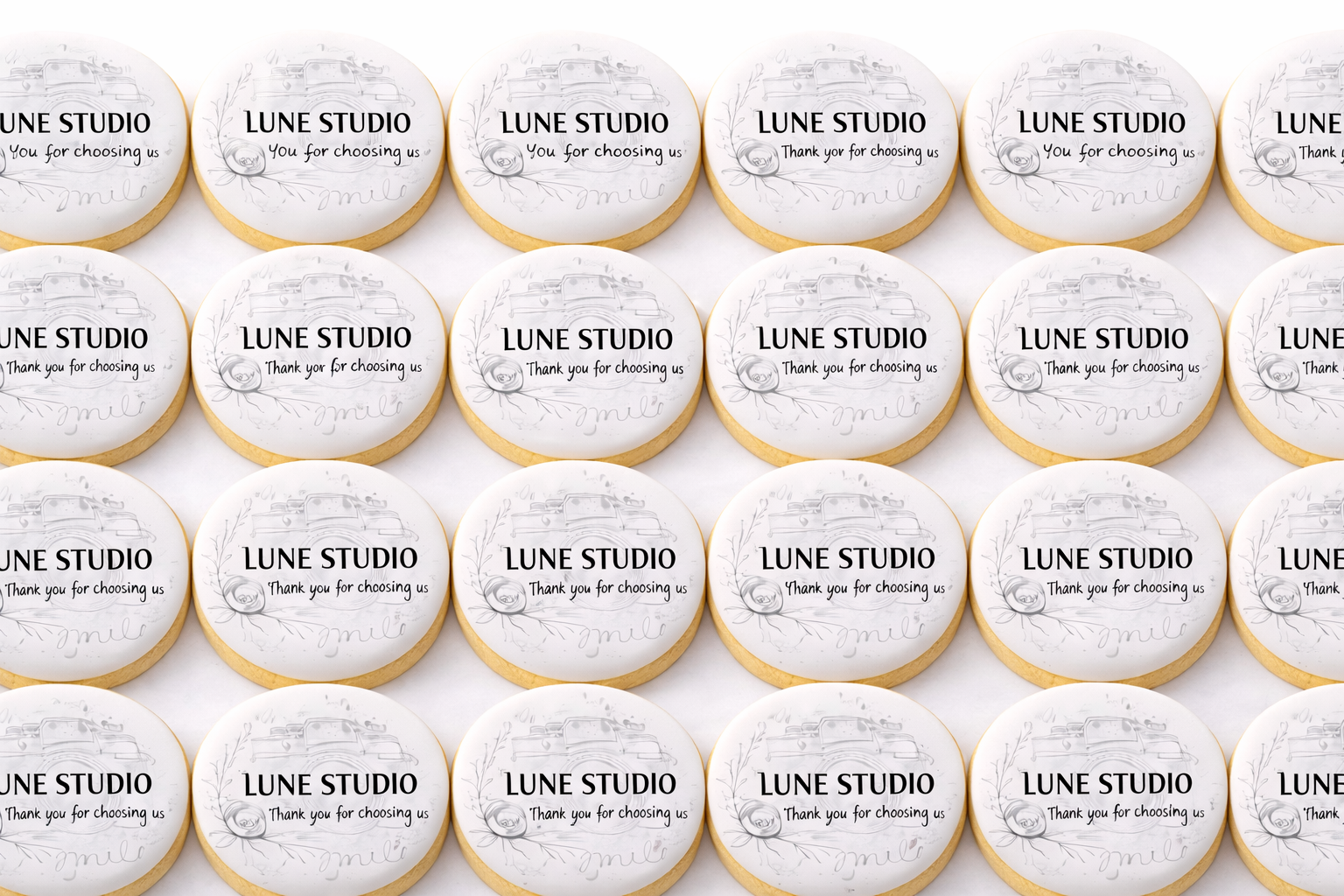 Decorated cookies on a tray celebrating a grand opening and launch party, featuring champagne bottles, stars, and message cookies.