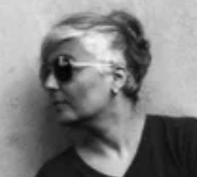 Beldan Sezen book artist  olive skin woman with short hair and sun glasses, looks to the left 