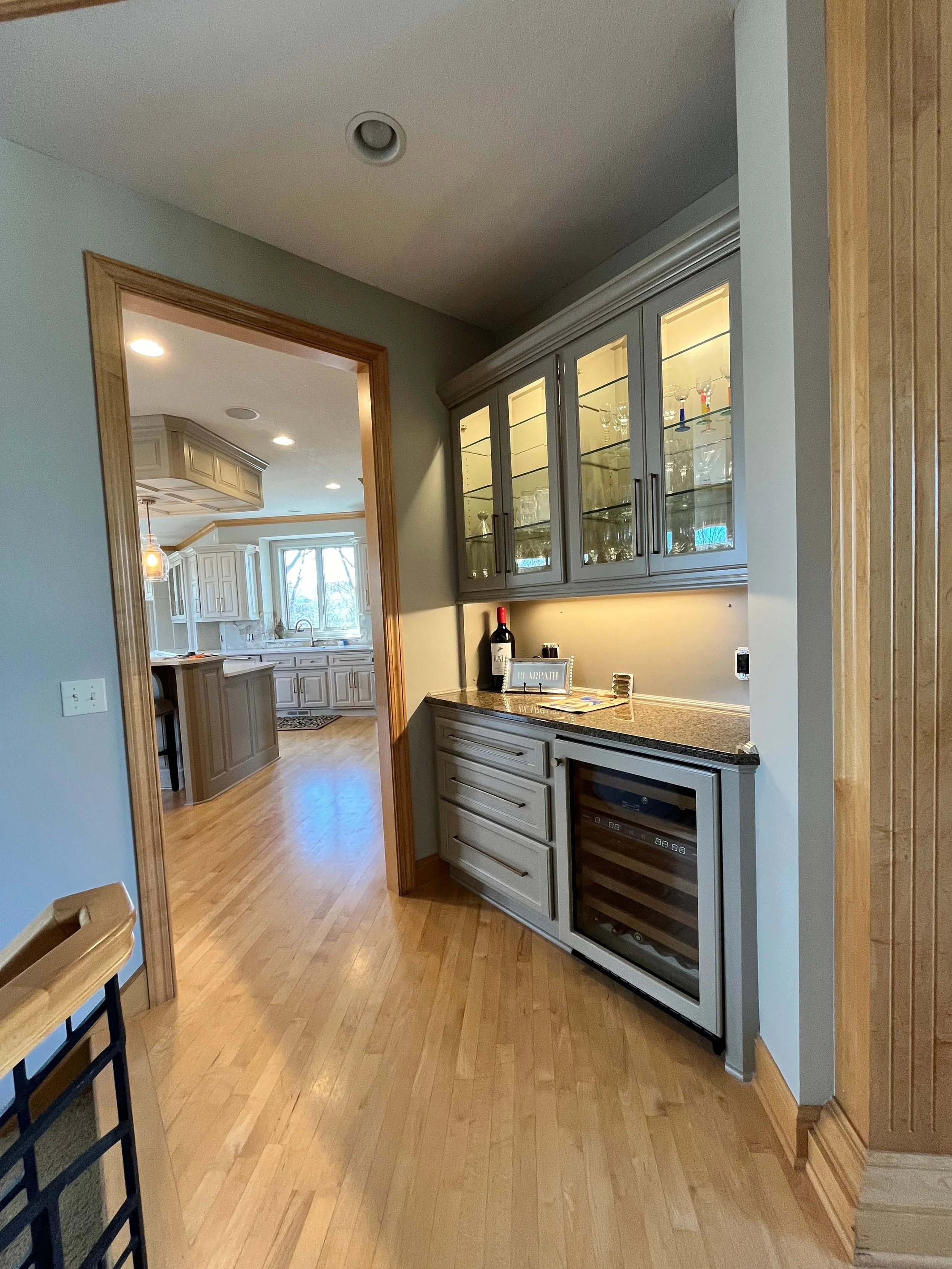 Detailed cabinetry painting and wall finishes in a modern butler's pantry completed by home painters mn.