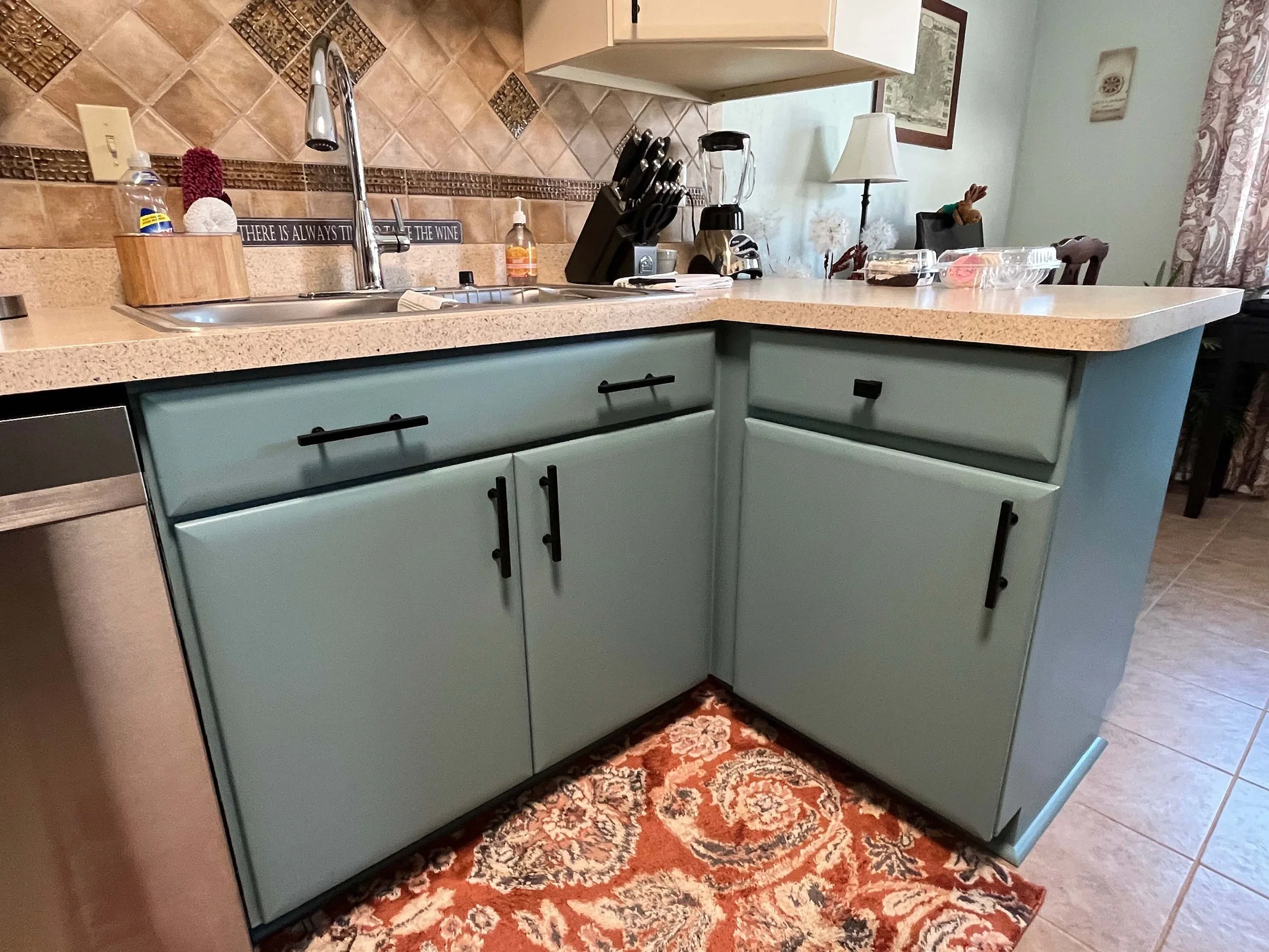 Detailed view of professionally refinished kitchen cabinetry showcasing smooth, durable application by home painters mn.