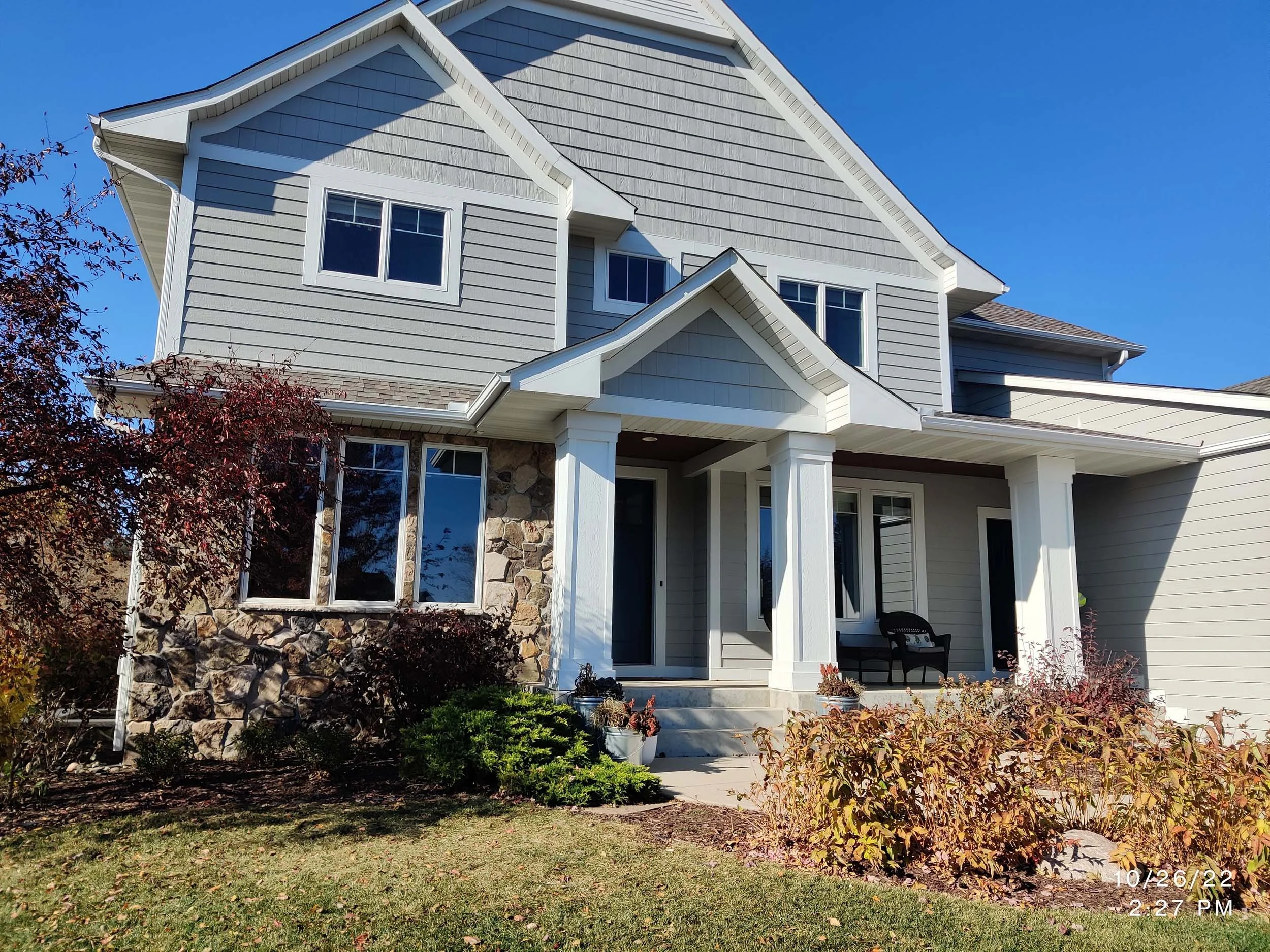 Modern grey residential home with professional exterior painting by The List, premier painters in Minneapolis, MN.