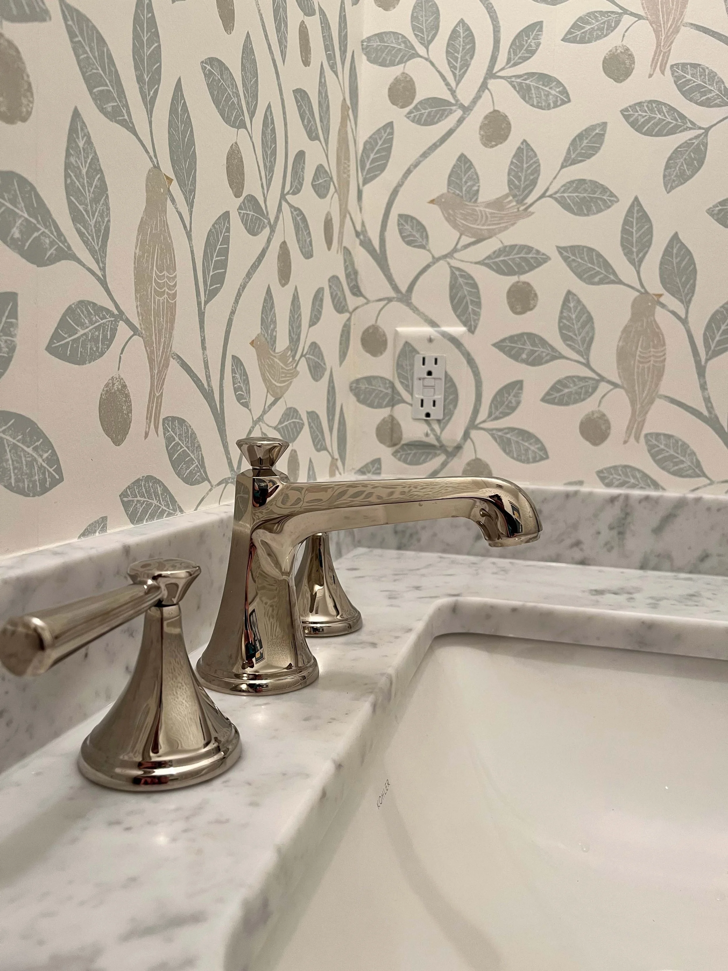 Close-up of a delicate leaf-patterned wall covering installed with precision by an expert wallpaper installer.