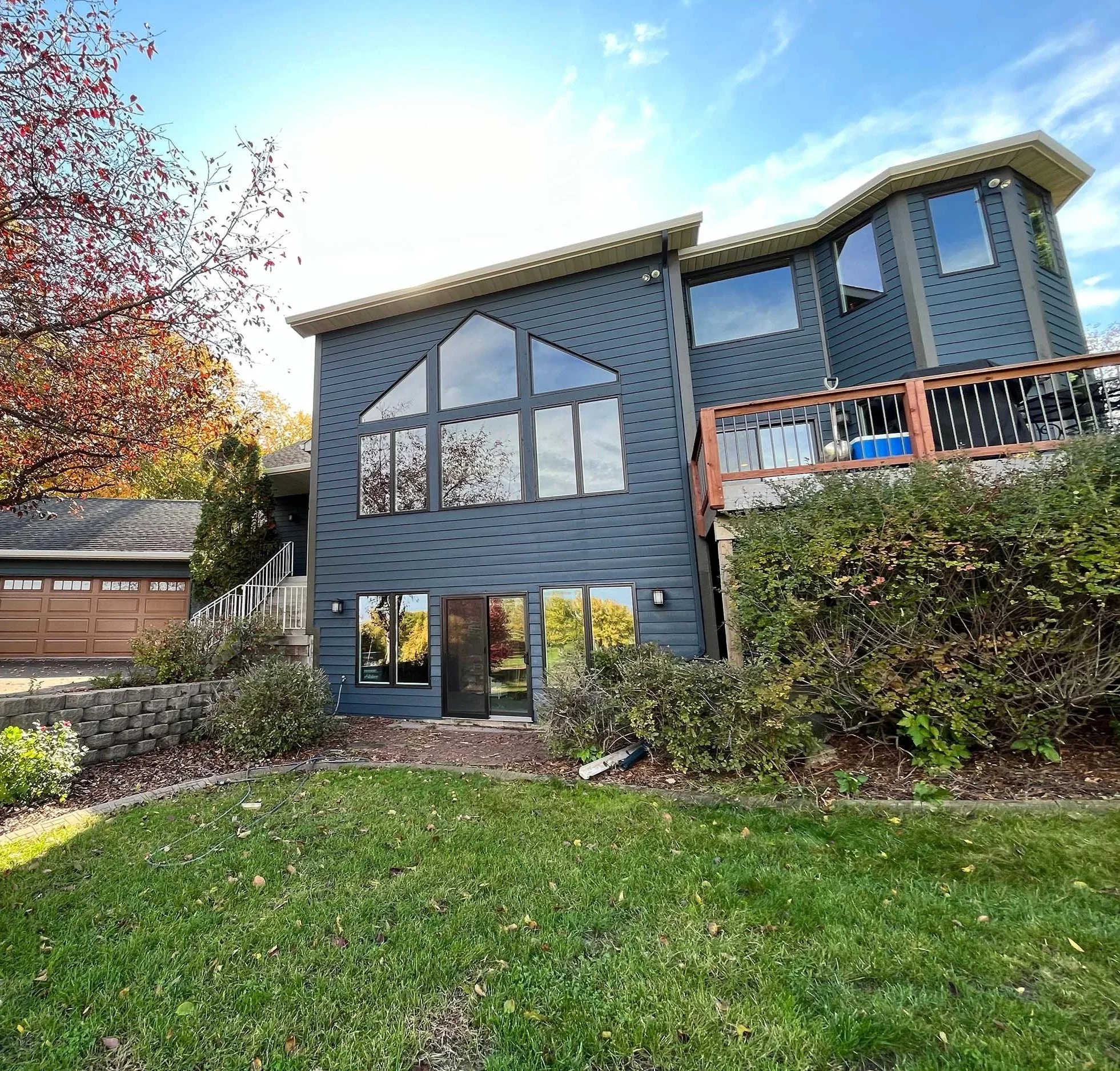 Modern residential exterior professionally painted in a dark gray finish by house painters in Minneapolis.