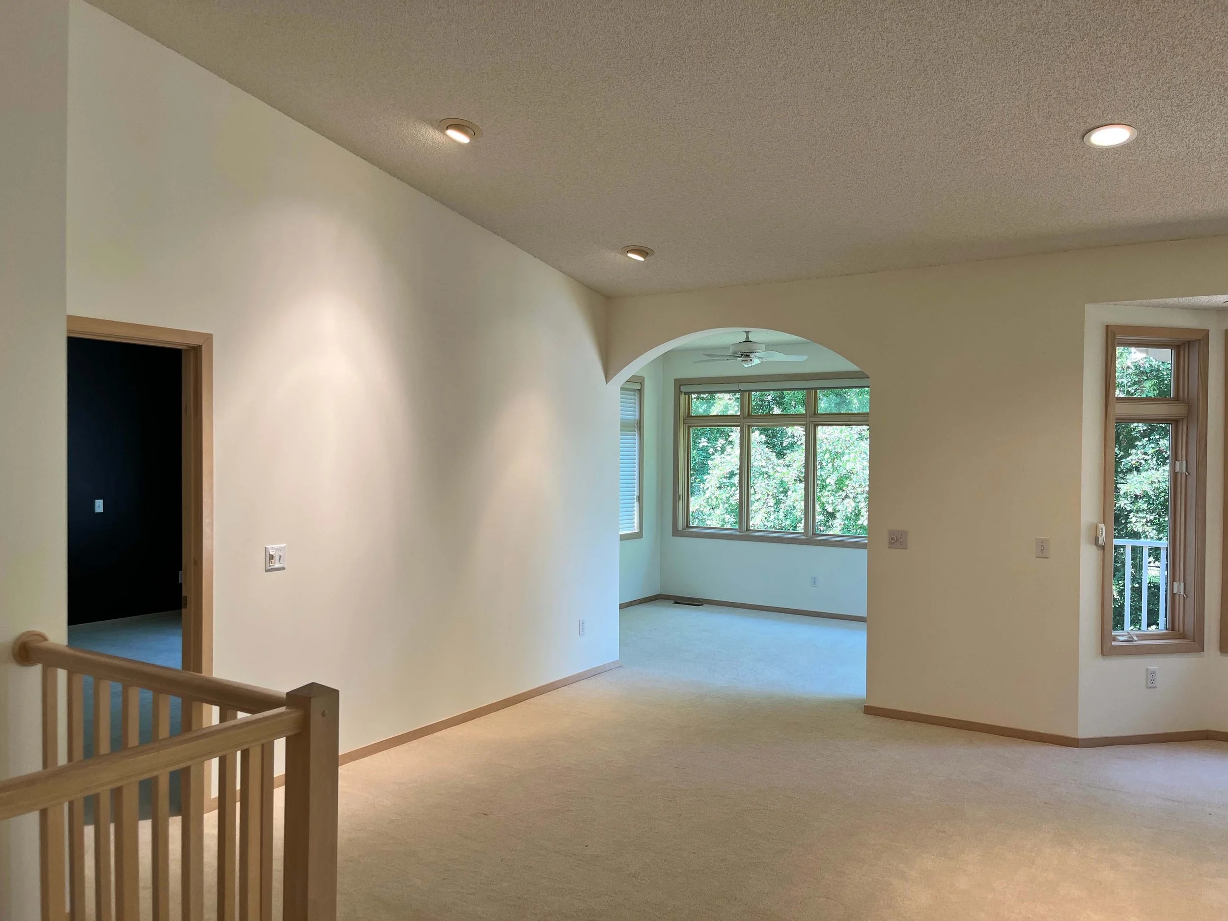 Professional interior painting of an open-concept living space featuring clean neutral tones and expert coverage by home painters mn.