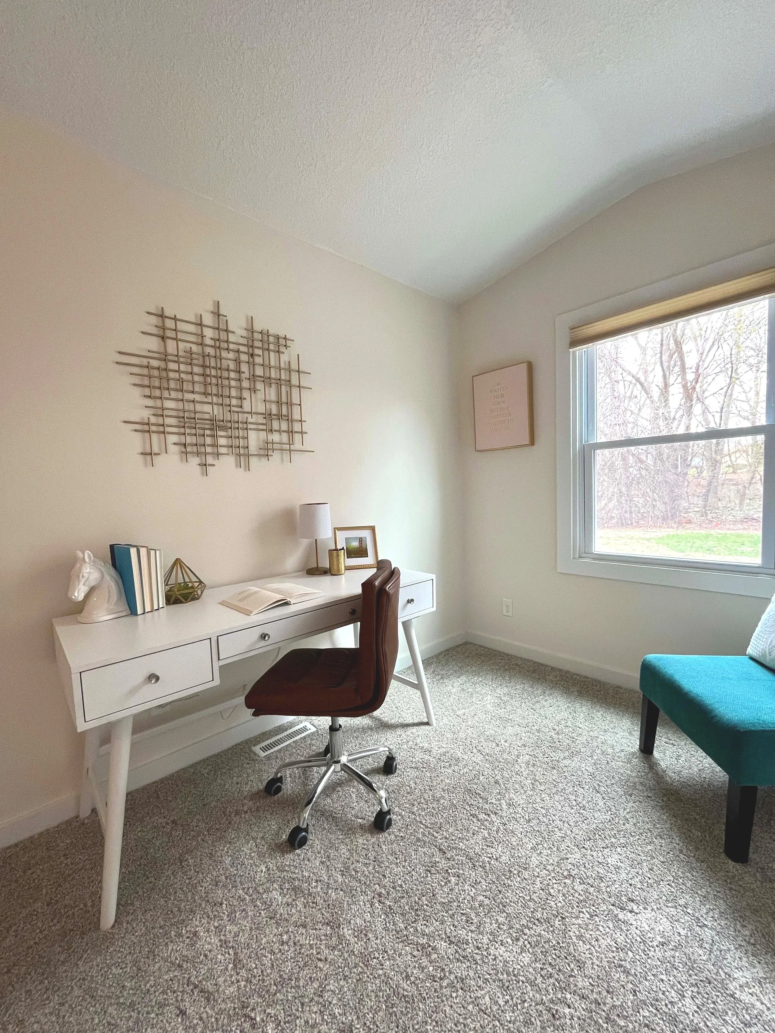 A professionally painted, bright home office with a white desk and teal chair, demonstrating high-quality results for residential painting services for realtors in Minneapolis.