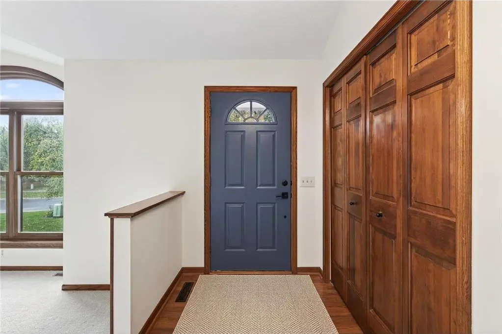 House interior slate blue door with white walls and dark brown trim painted by The List painting contractors