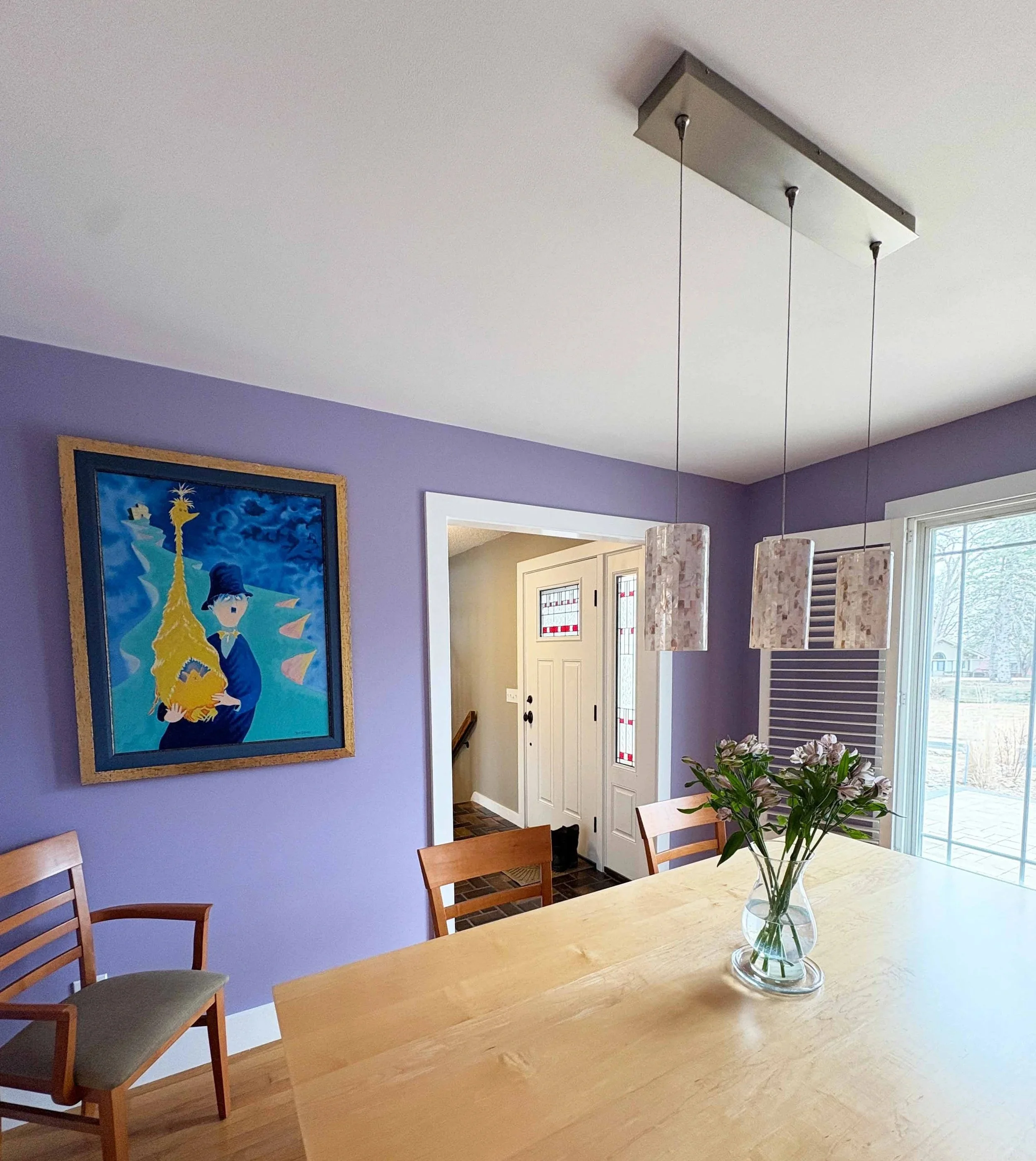 Lavender dining room interior with professional wall painting and trim work by The List in Minneapolis, MN.