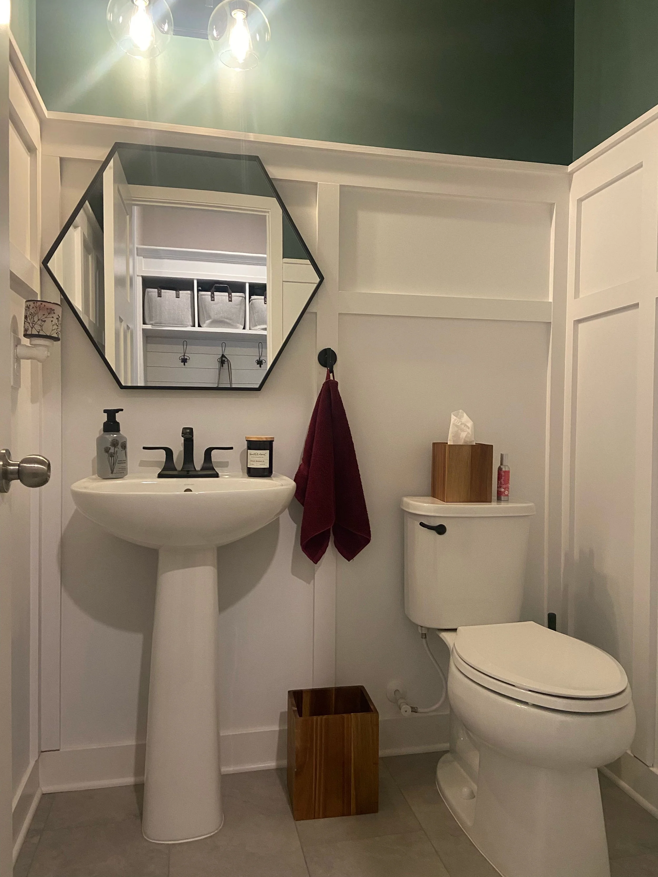 A crisp, bright residential bathroom featuring professional painting and a custom mirror installation.
