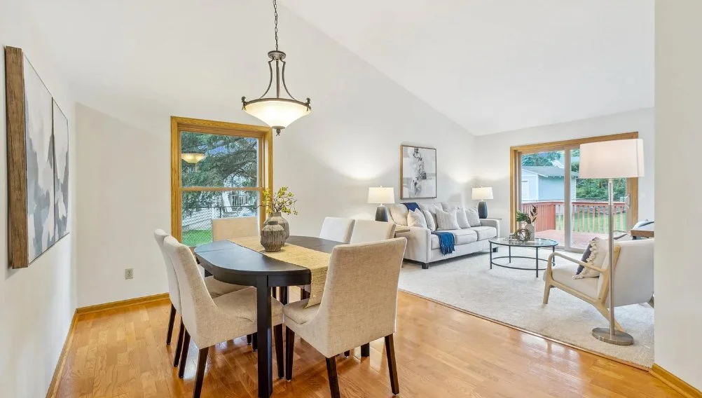 A bright, open-concept living and dining room with fresh neutral paint, showcasing move-in ready results from professional painting services for realtors in Minneapolis.