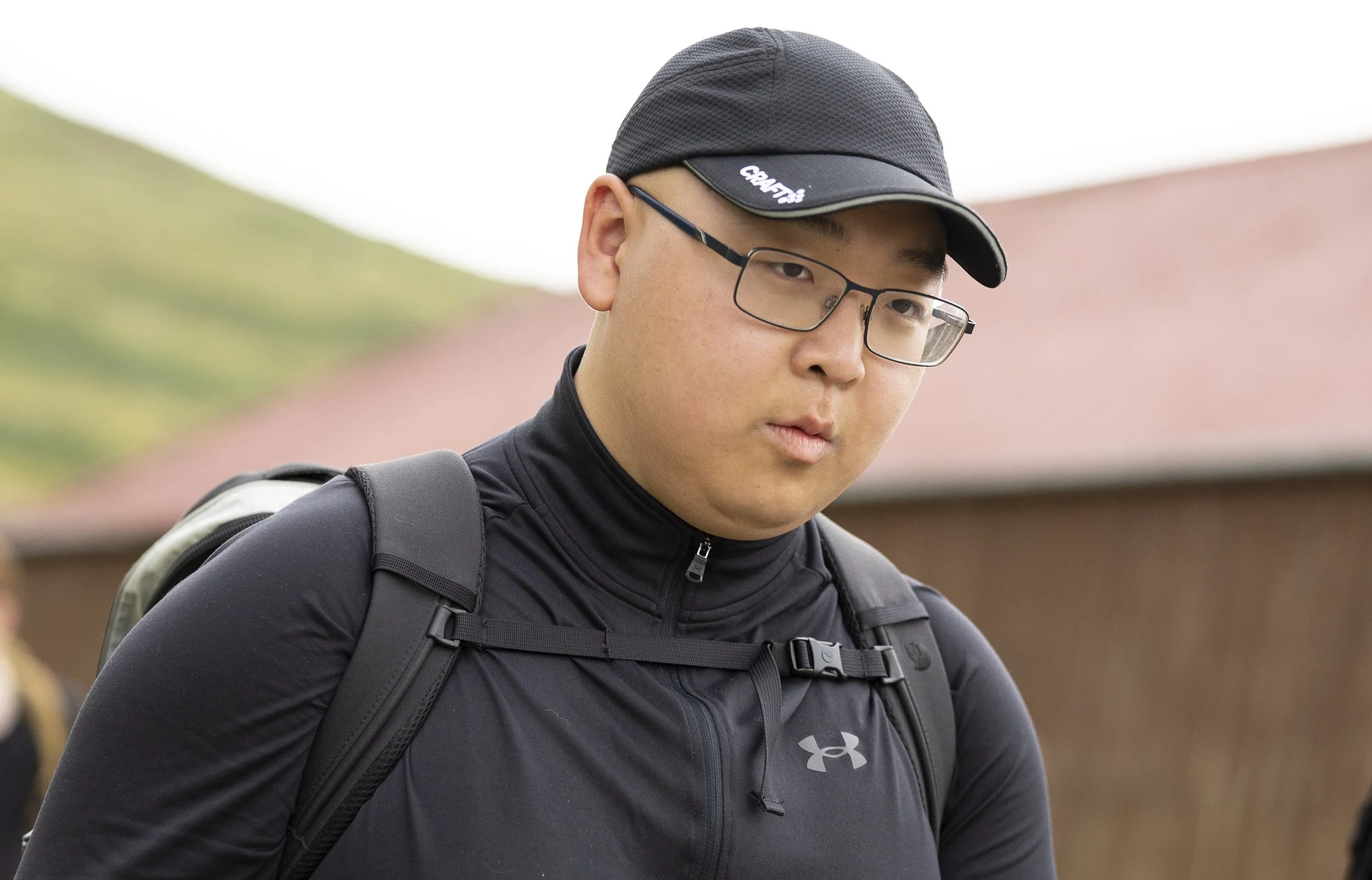 A young man with rucksack in the countryside.