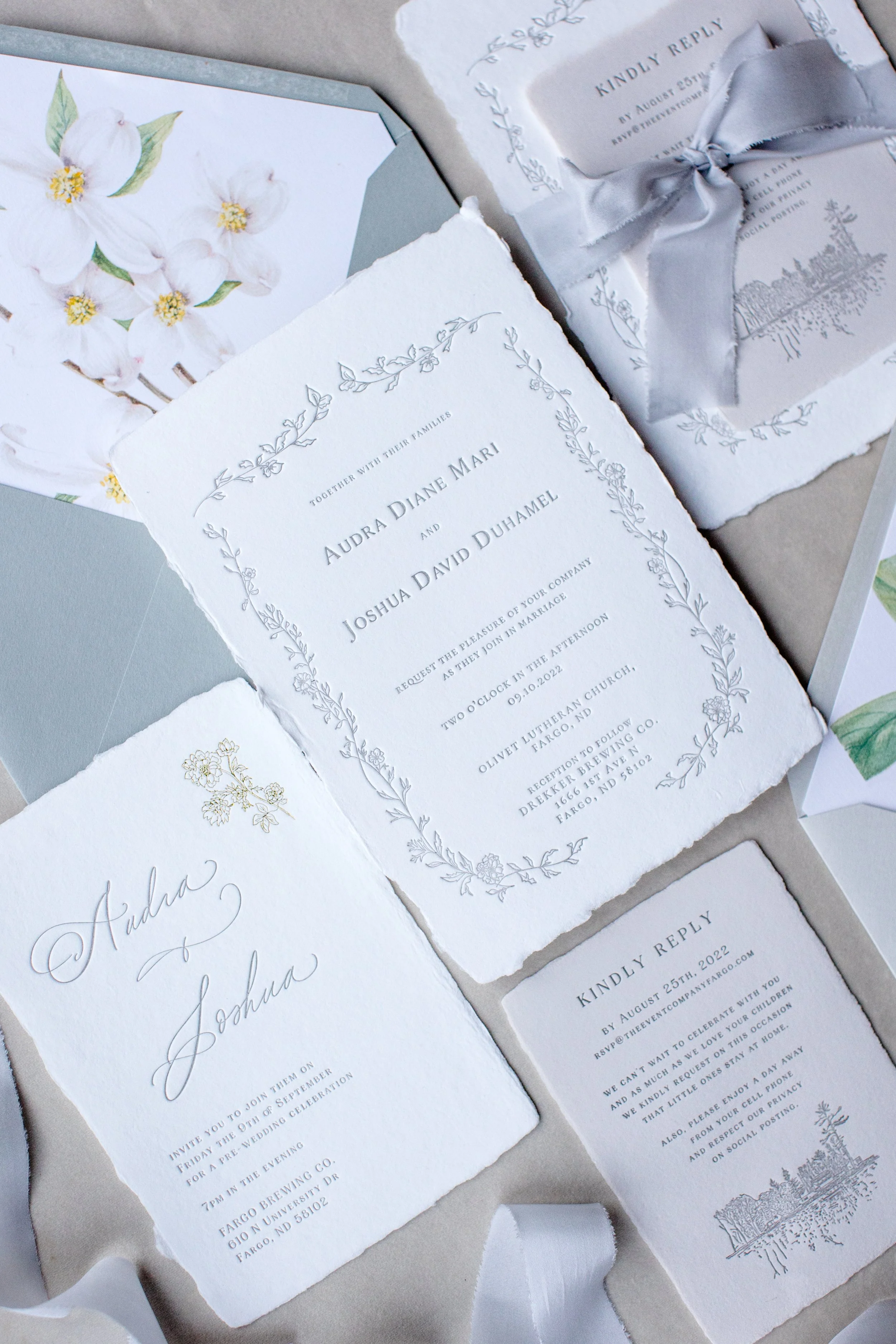 Set of wedding invitation cards with elegant floral designs, handwritten calligraphy, and RSVP cards.