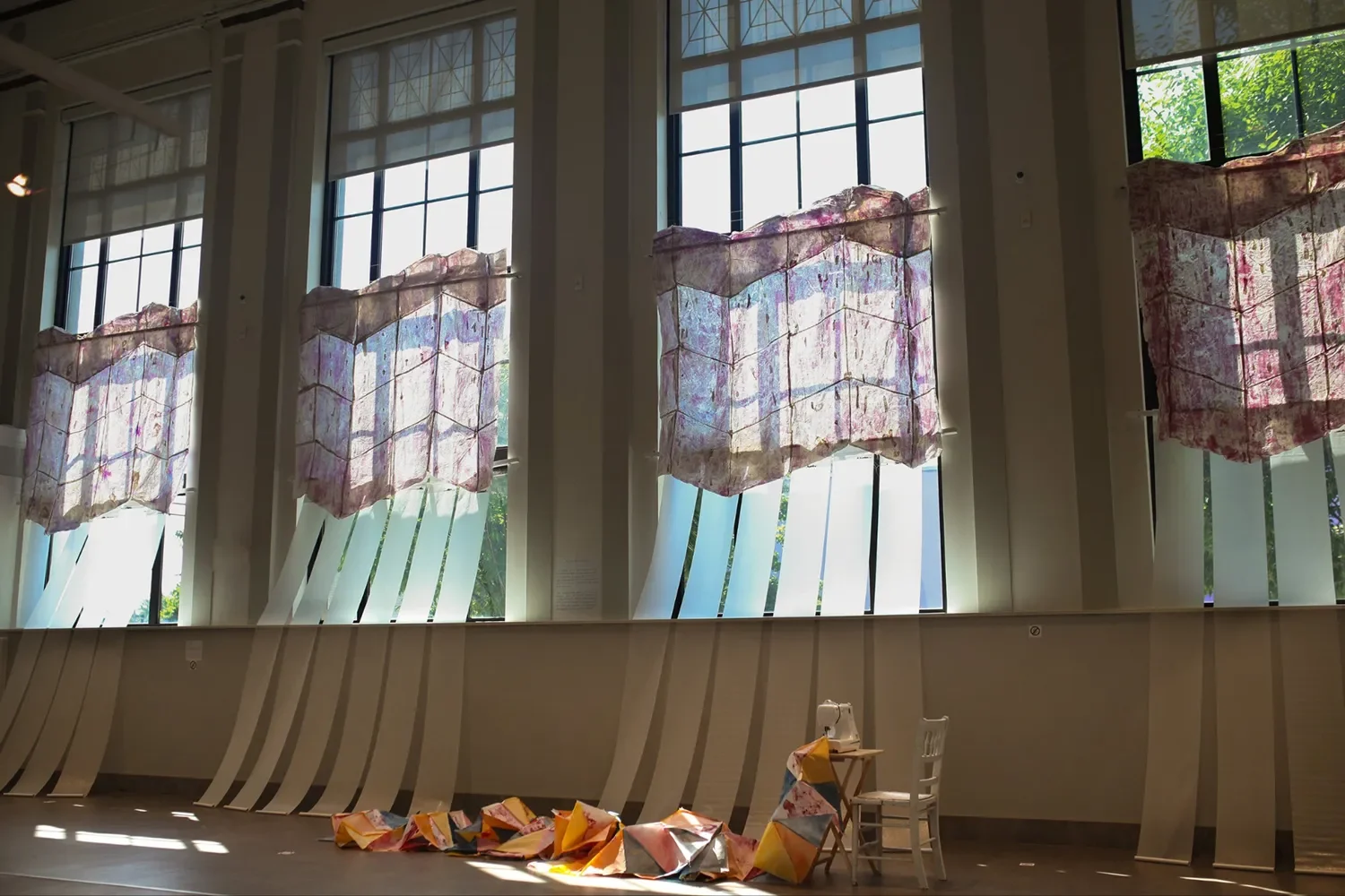 Elaine Elledge Elaine Elledge is a printmaker and installation artist who embraces the quiet power of fragility, imperfection, and impermanence. She uses domestic practices and products to construct layered installations and paper-based quilts. Elled