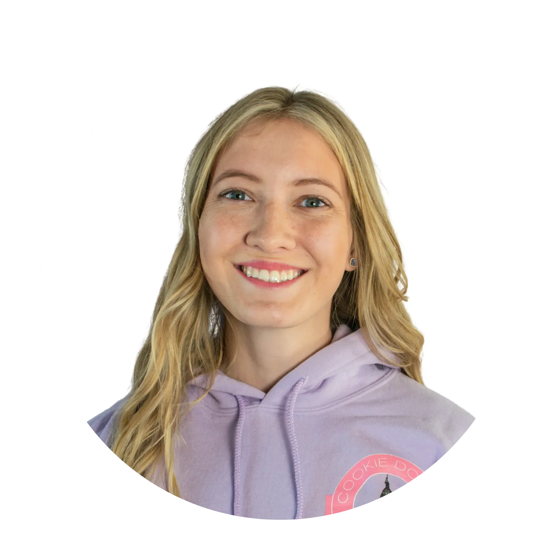 A young woman with long blonde hair, blue eyes, and a bright smile, wearing a lavender hoodie with a pink logo on the chest.