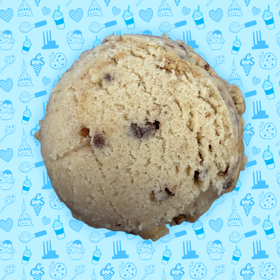 Peanut butter cookie dough scoop with a creamy texture on a blue Capital City Sweets patterned background.