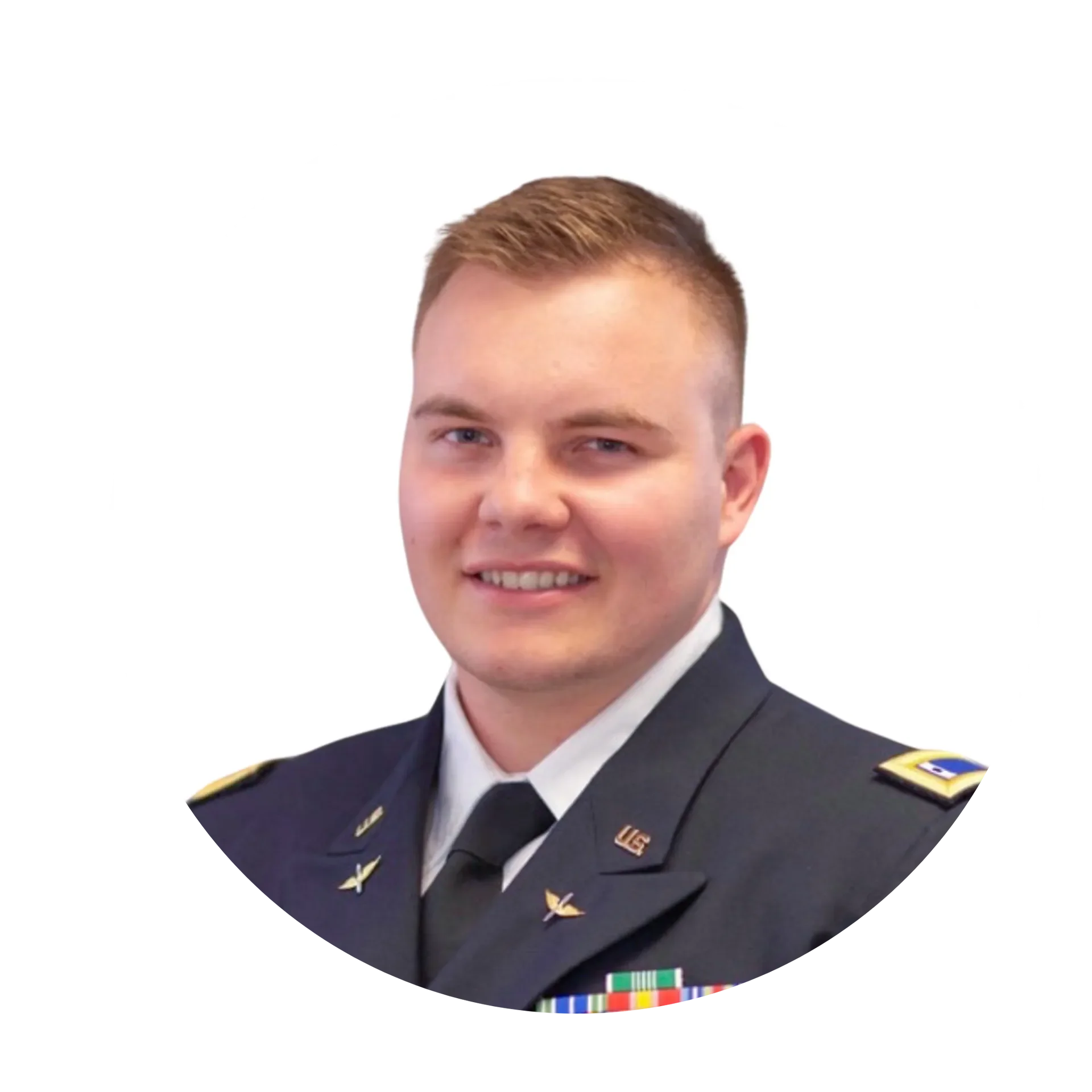 Portrait of a young male in a U.S. Air Force uniform, smiling, with short light brown hair and a white background.