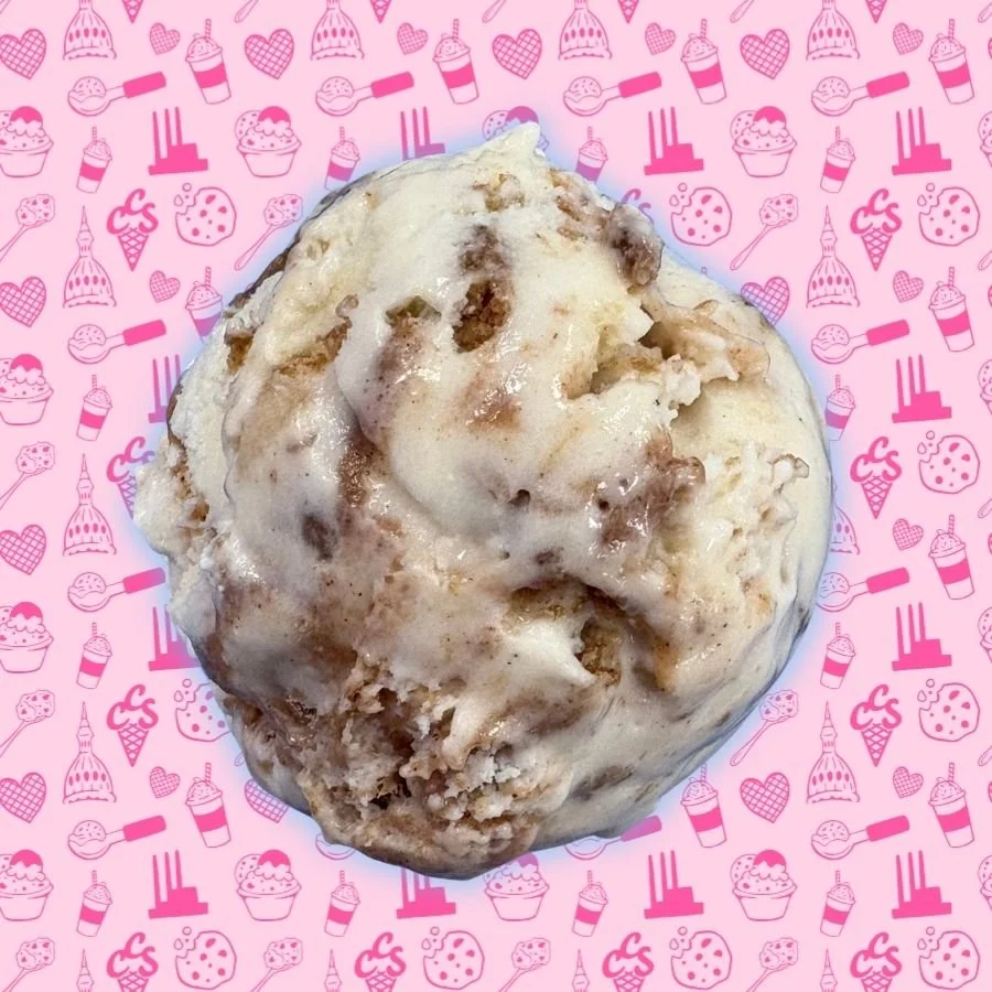 Scoop of apple crisp ice cream with cinnamon swirl and baked apple pieces on pink Capital City Sweets background.
