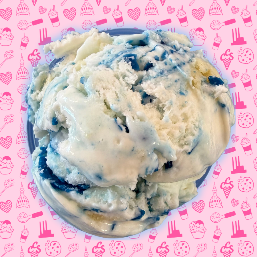 Birthday cake ice cream with blue frosting swirls and cake pieces on a pink Capital City Sweets patterned background.