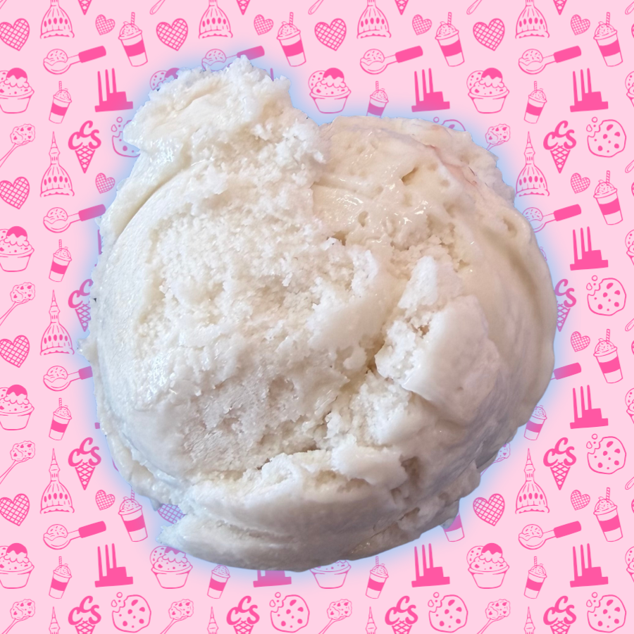 Creamy dairy-free vanilla ice cream scoop with a smooth texture on a pink Capital City Sweets patterned background.