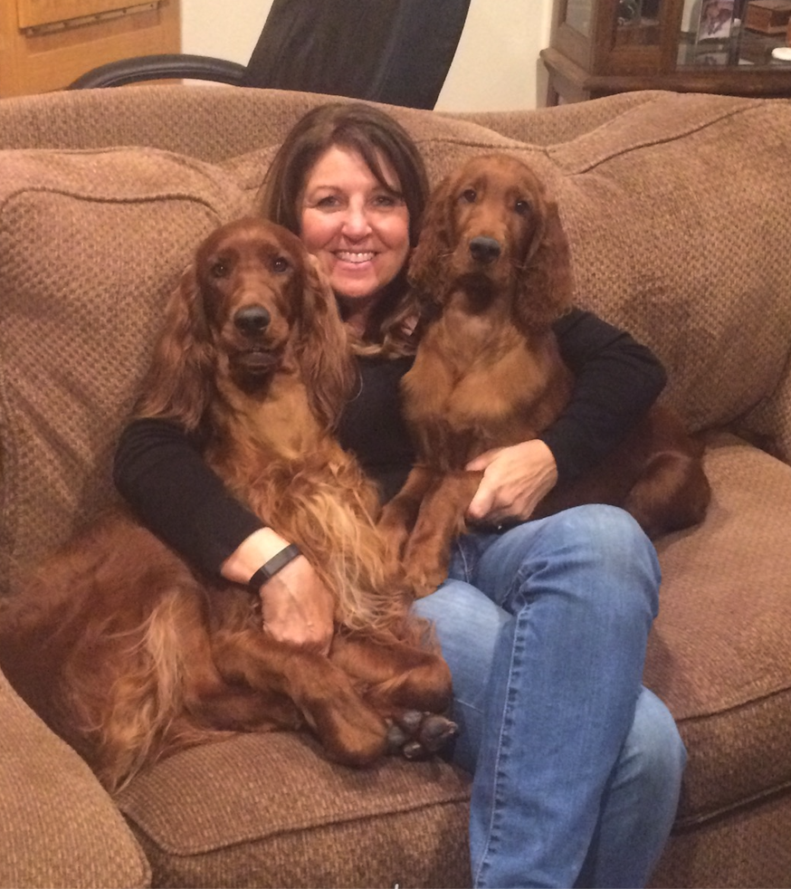 AKC Evaluator and Judge with her two Irish Setter dogsolding awards from obedience and competition events