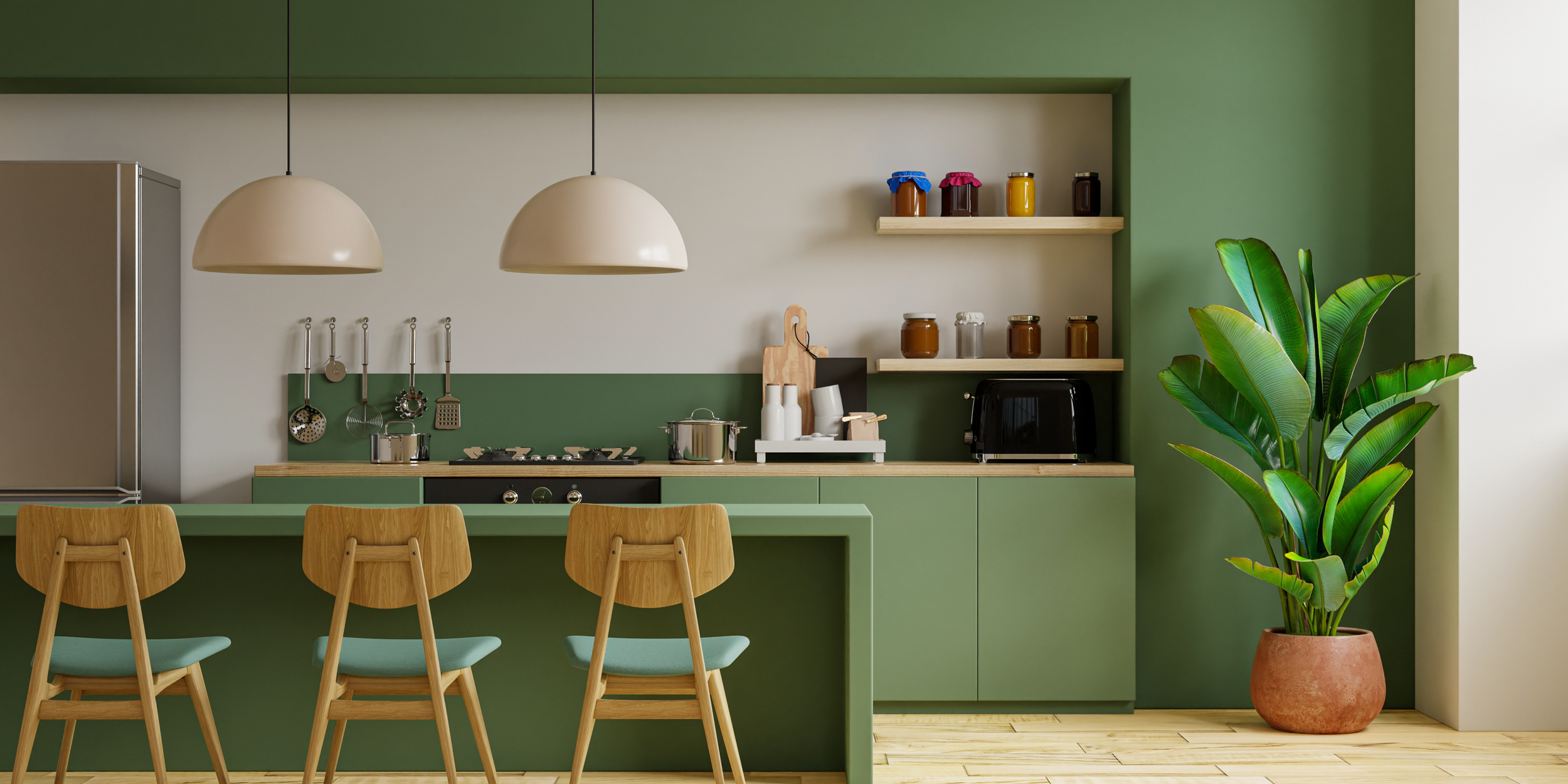 Modern kitchen with green and white walls, light wood flooring, three wooden bar stools with mint green cushions, green kitchen cabinets, a large potted plant, hanging pendant lights, and shelves with jars and kitchen utensils.