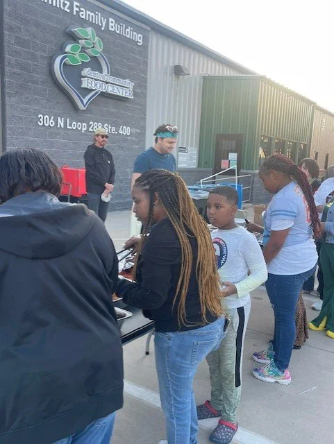 Volunteers and community members attending a Denton Affordable Housing Corporation partner event