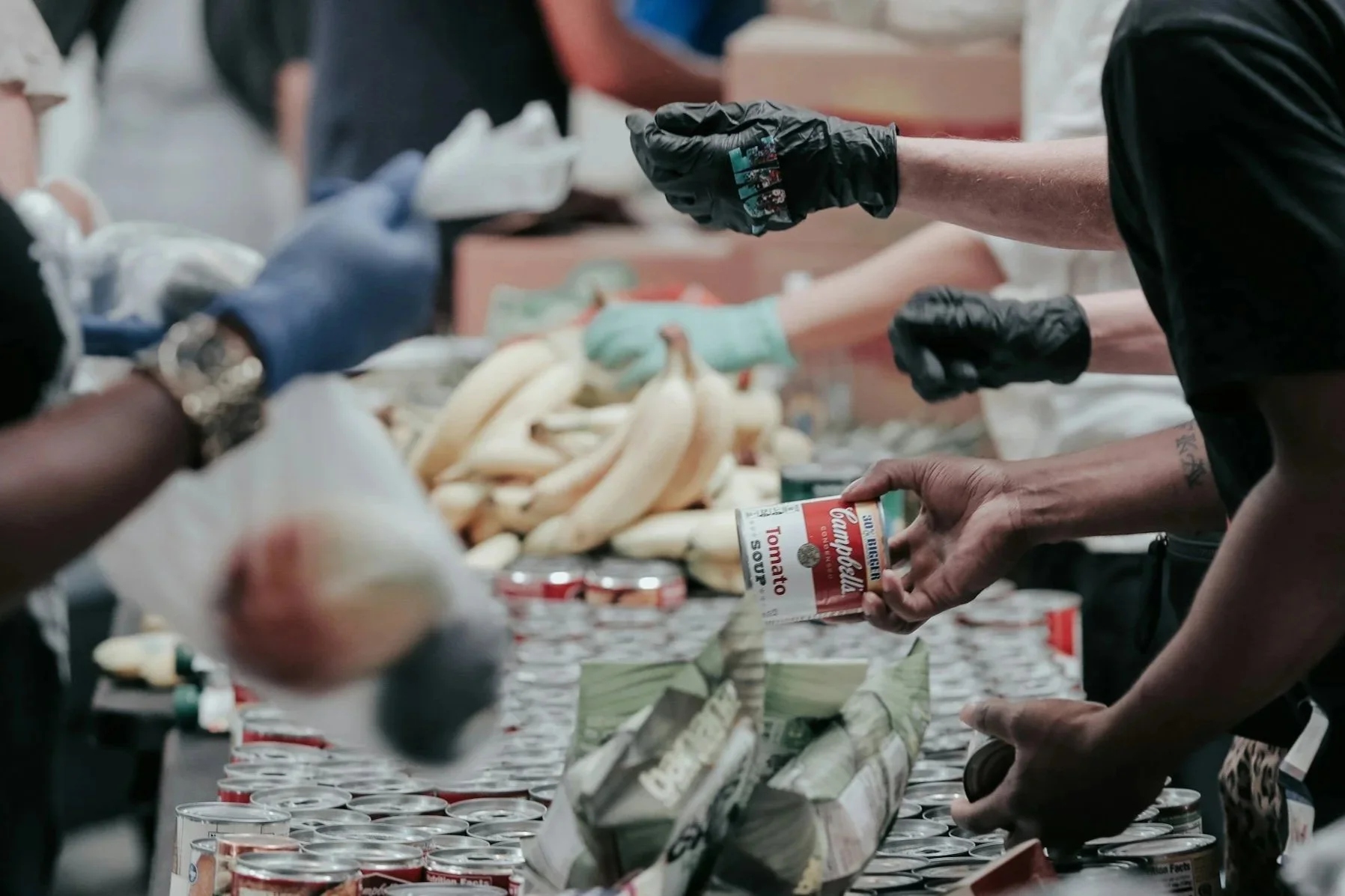 Photo of volunteers giving away food and basic necessities at a Denton Affordable Housing Corporation Partner's event