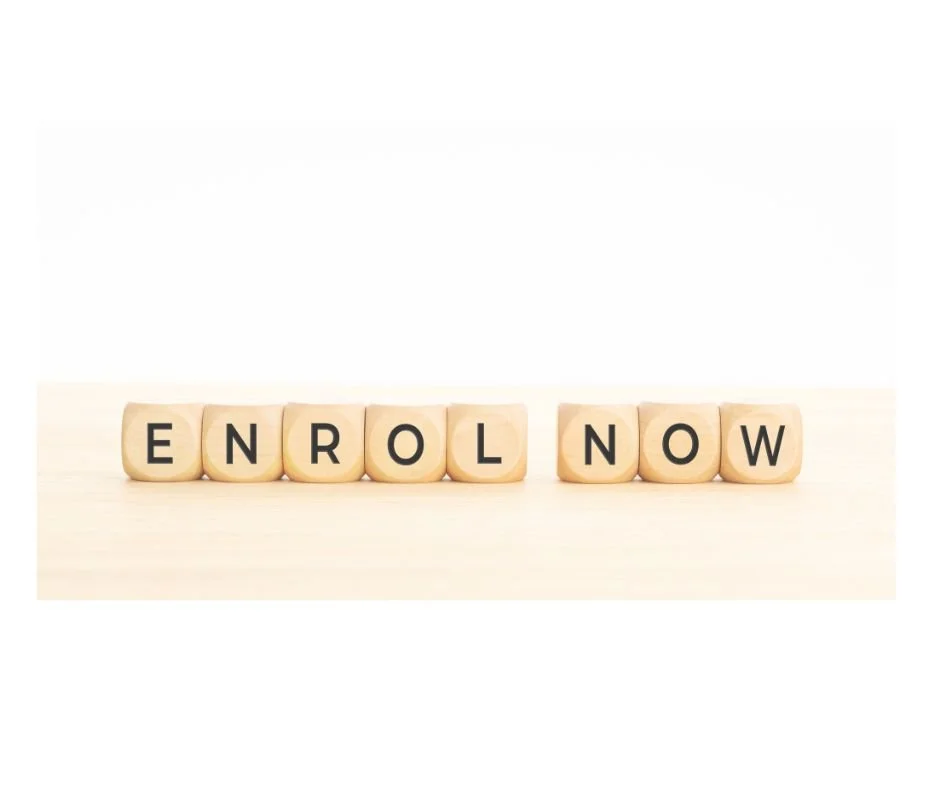Wooden blocks spelling out 'ENROLL NOW' on a light-colored surface.