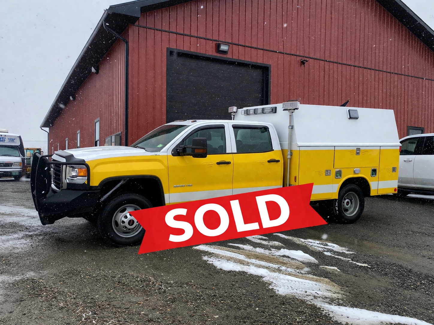Snowy lot with sold utility truck.png
