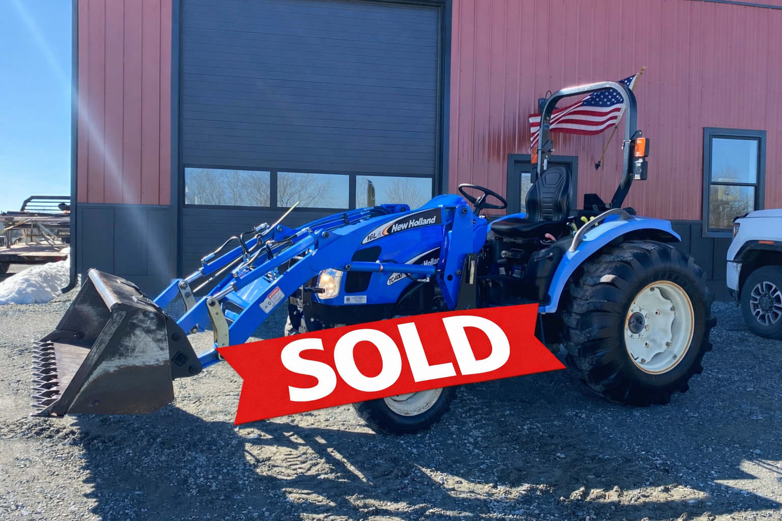 Blue New Holland tractor with sold banner.png