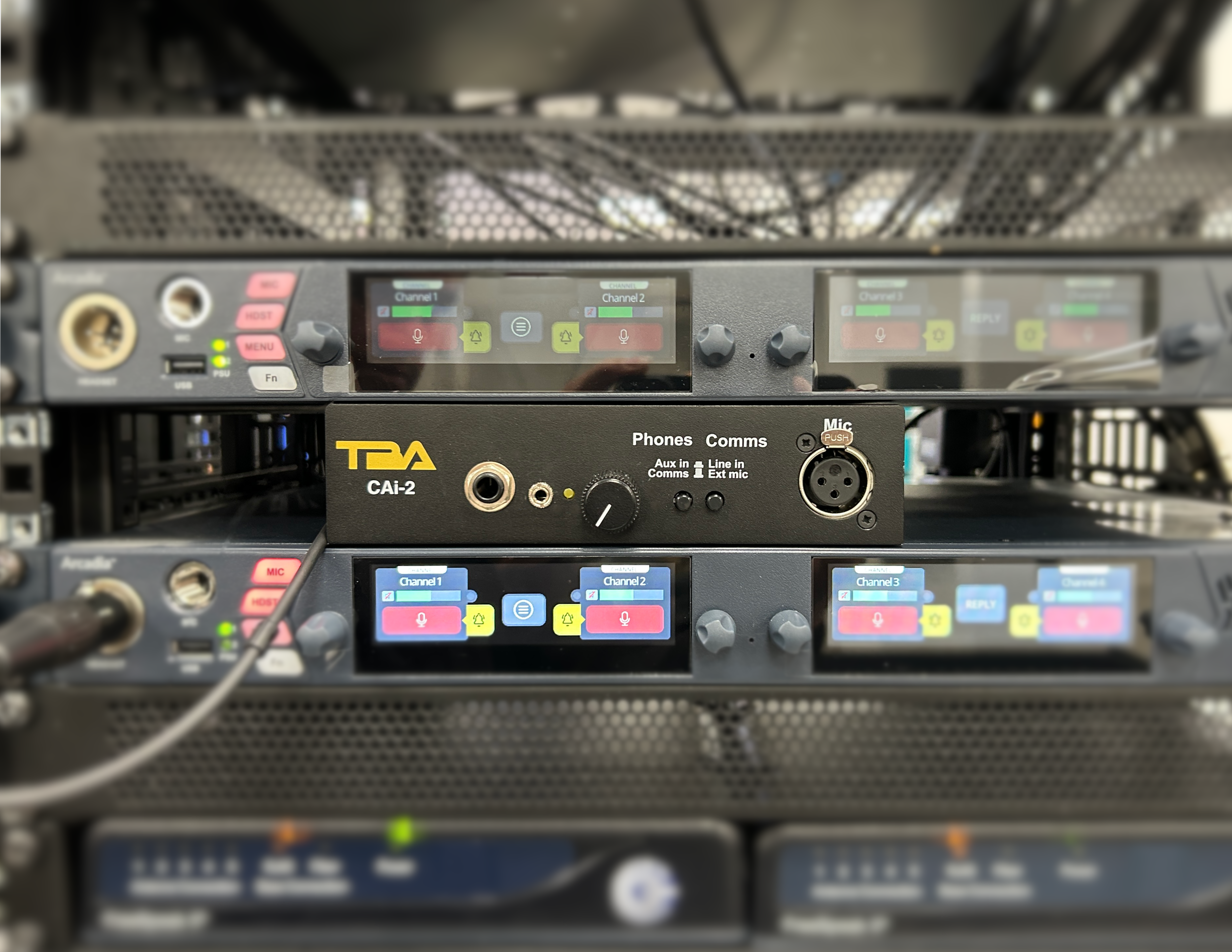 Close-up of a professional audio mixer with multiple channels, knobs, buttons, and a digital display showing audio levels for channels 1 and 2, used for sound engineering or live audio control.