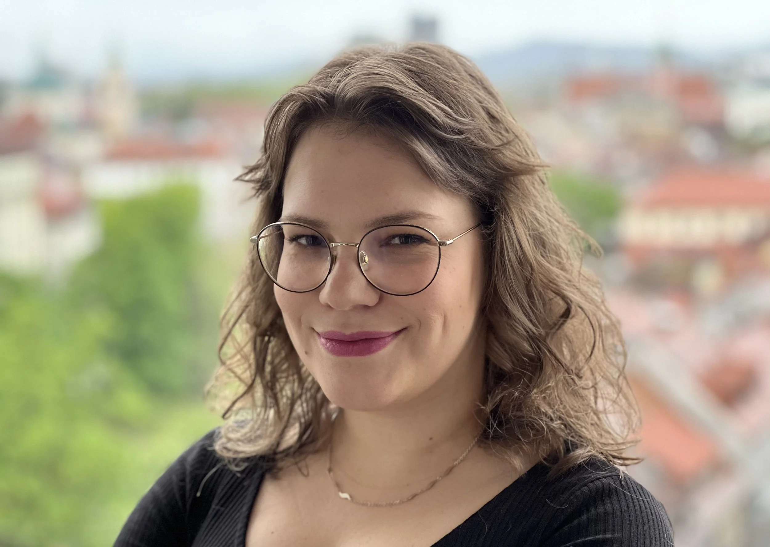 Portrait image of Eva Eric with curly brown hair