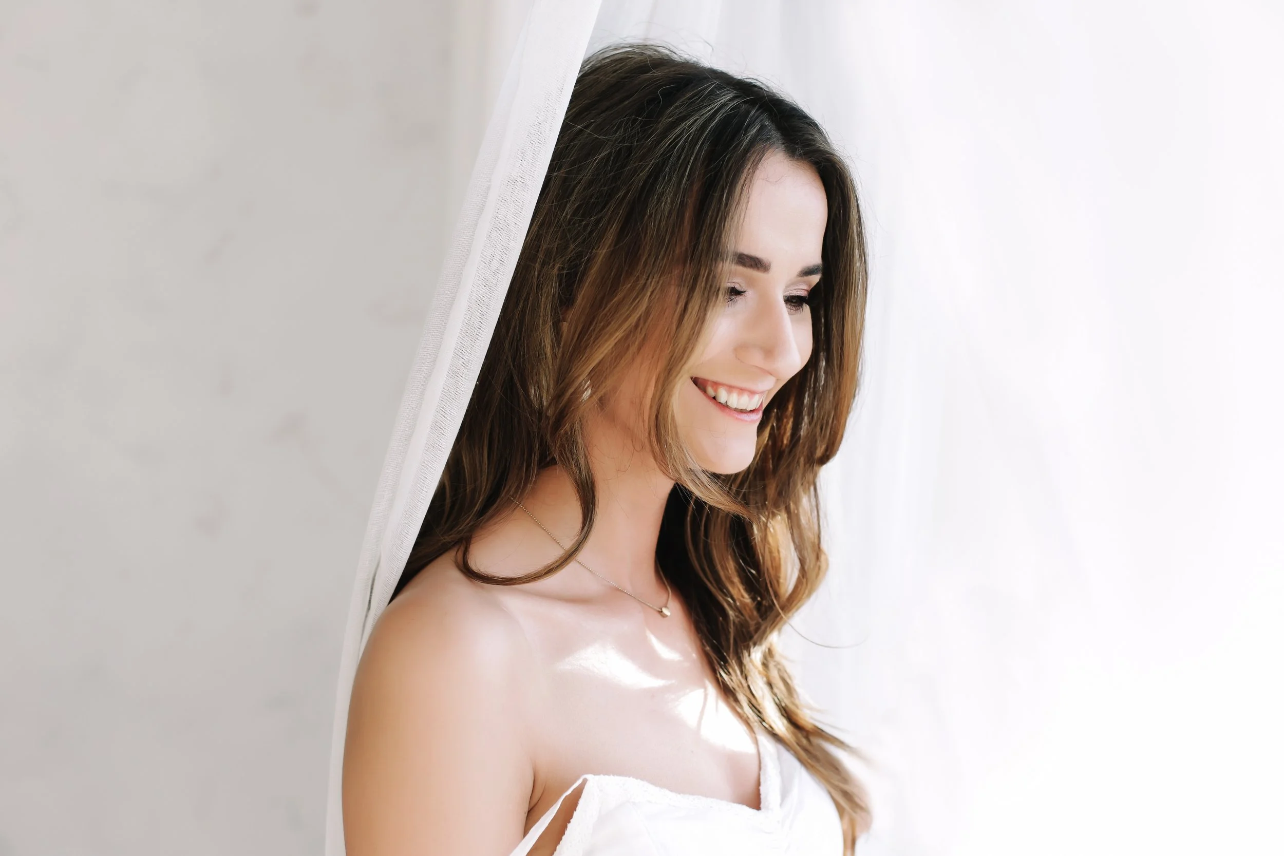 Woman with healthy glowing skin preparing for a wedding or special event in soft natural light at med spa in Woodbridge, VA