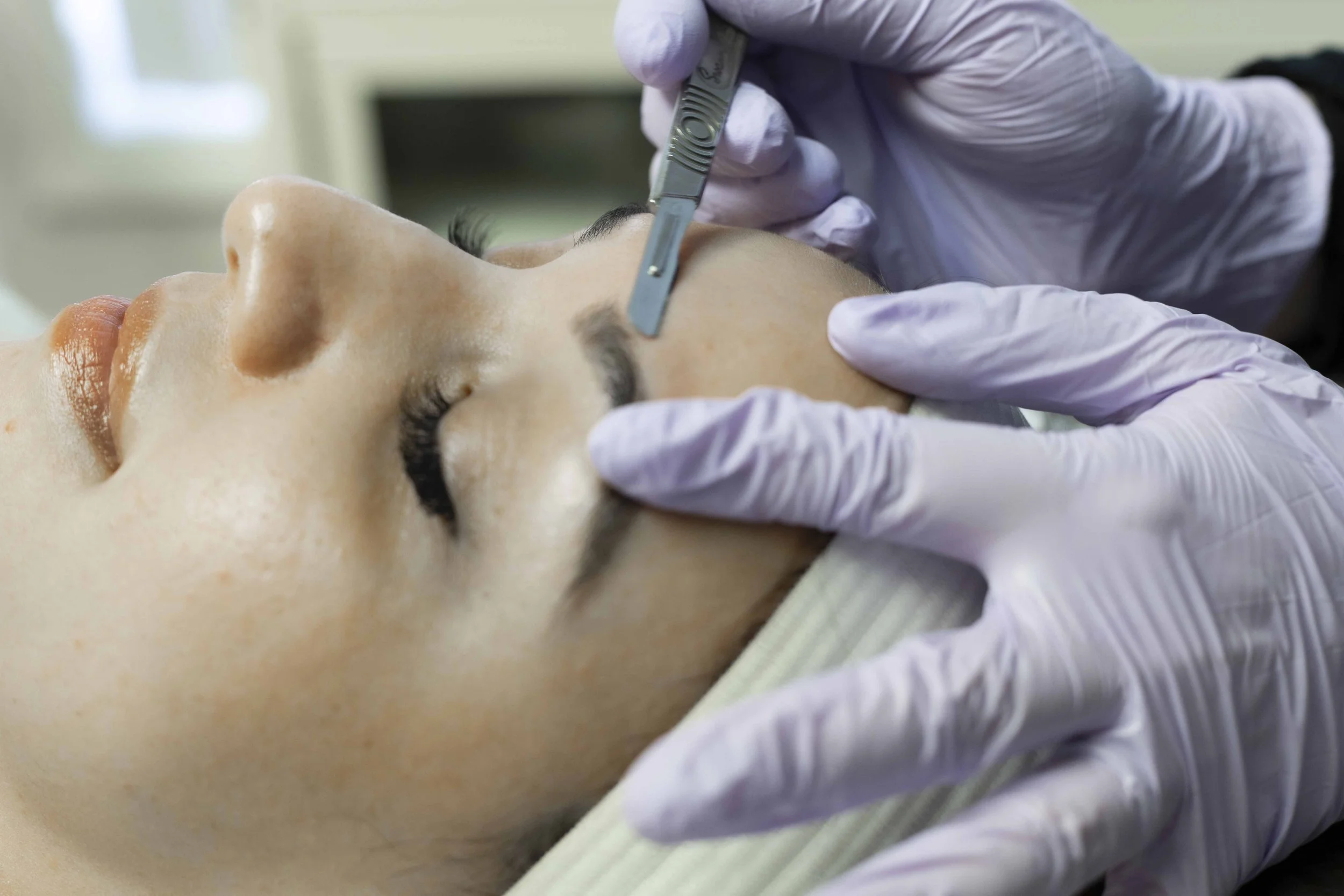 Dermaplaning facial enhancement smoothing skin and removing peach fuzz at Eleva Glow in Woodbridge, VA