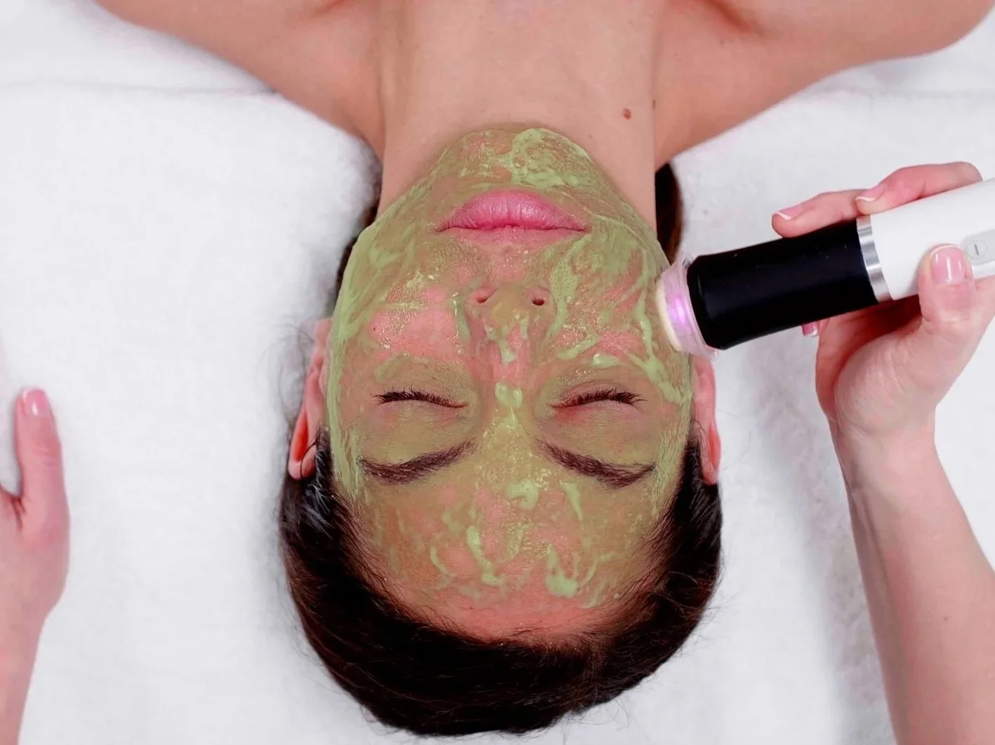 Geneo Glo2 Facial treatment being performed with green OxyPod exfoliation and oxygenation mask for bright, radiant skin