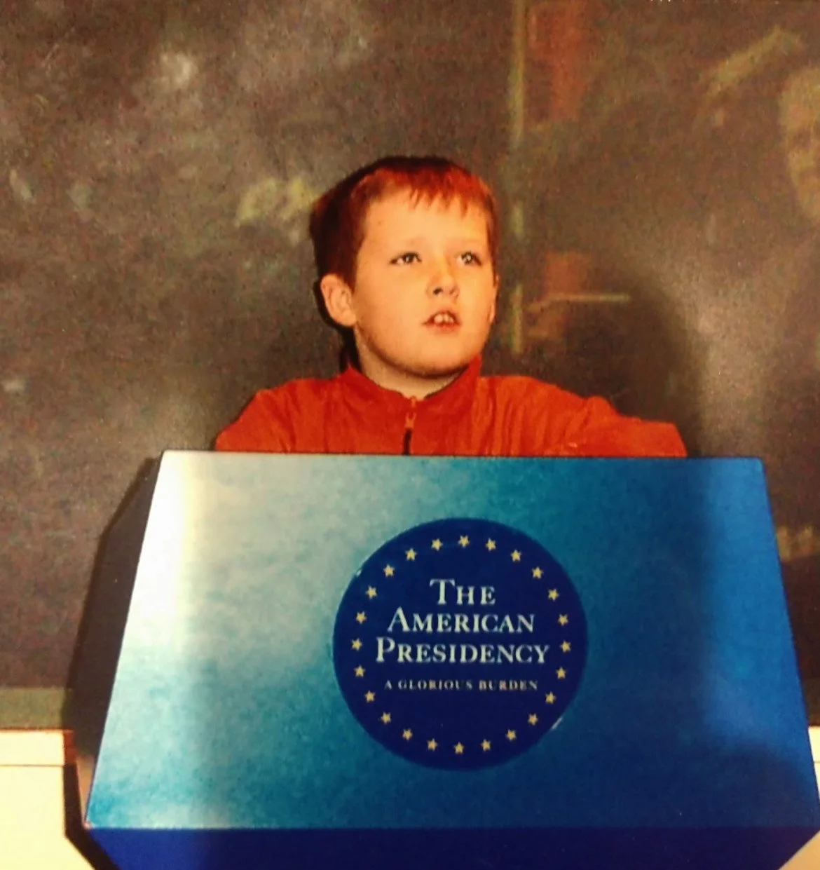 An old photo of Ben McAdams as a child, standing at a podium at the Smithsonian.
