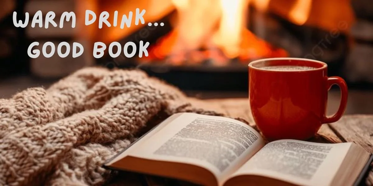 An open book, a red mug filled with a hot drink, a cozy knit blanket, and a fireplace in the background.