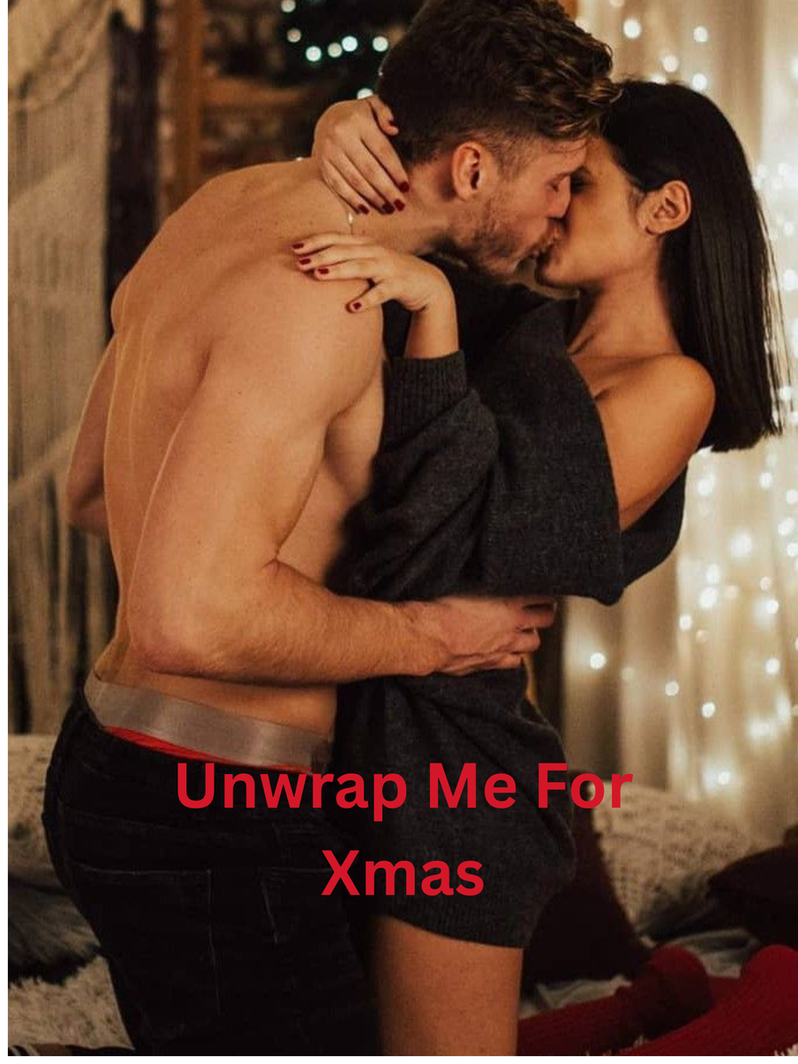 A shirtless man and a woman are embracing and kissing in a cozy, decorated room with Christmas lights. The woman is wearing a black outfit, and the man has his arm around her.