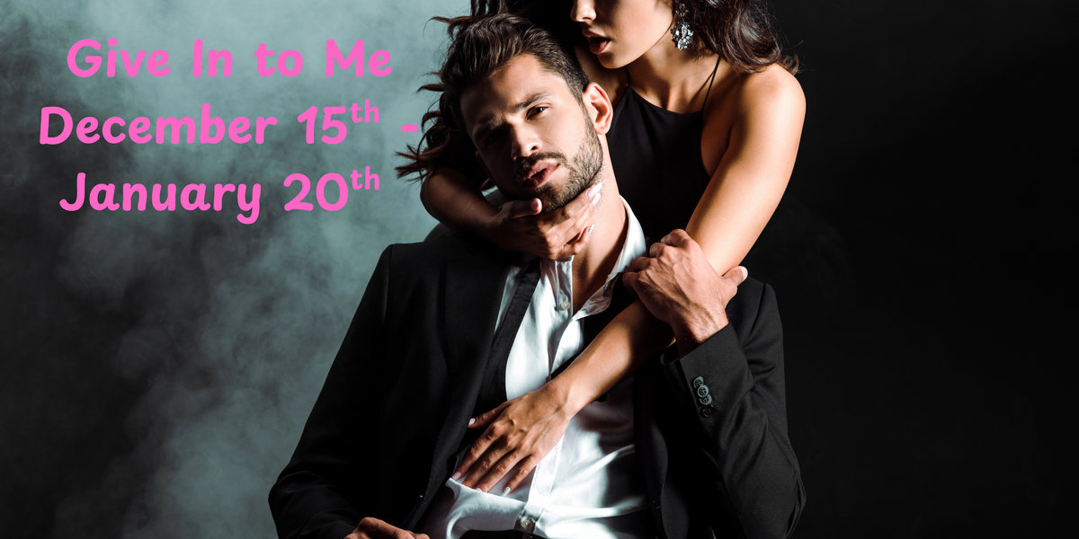 A man in a black suit and white shirt with a woman in a black dress posing closely together against a dark background, with pink text overlays reading "Give In to Me December 15th - January 20th."