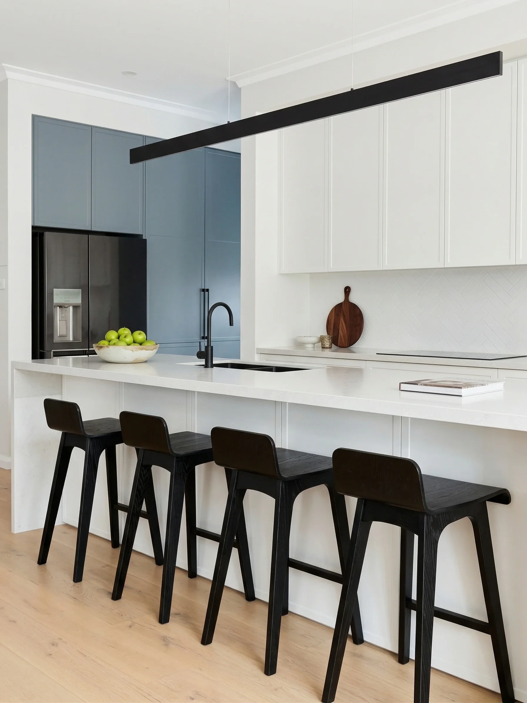 Luxury sized kitchen with white shaker style custom cabinetry and contrasting blue shaker style butler's pantry with quantum quartz light grey marbled island stone bench top in The Hills District by TruJoinery