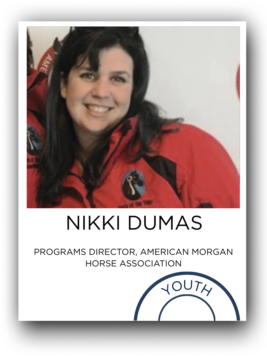Photograph of Nikki Dumas from the American Morgan Horse Association, wearing a red jacket with a logo, smiling at the camera.