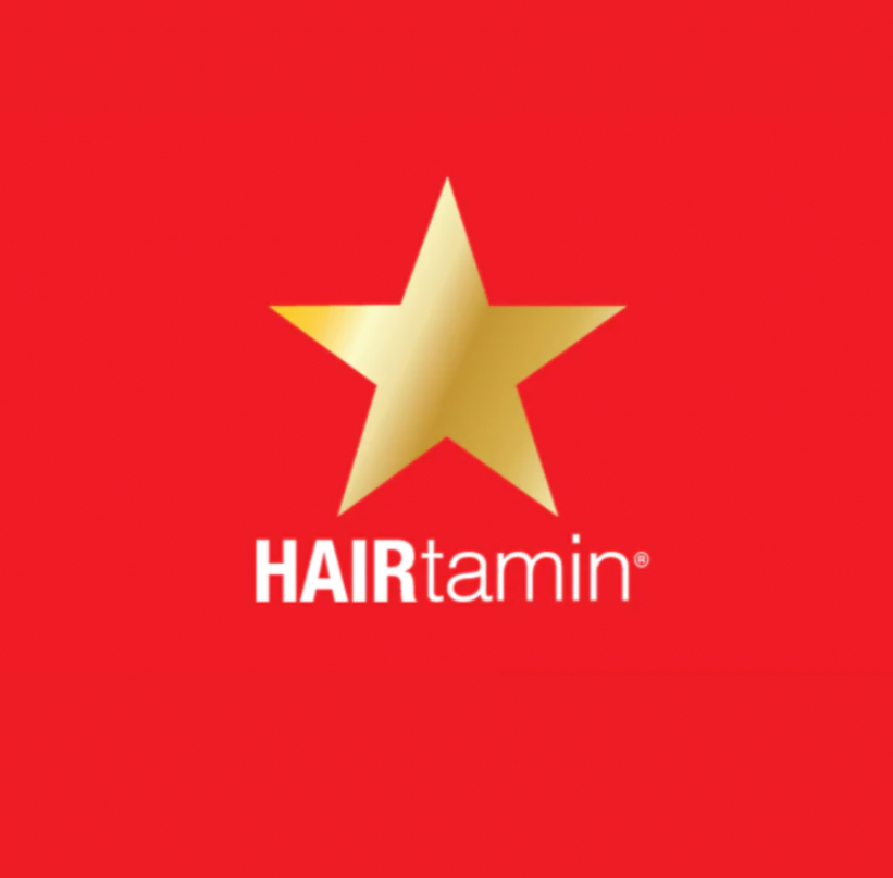 Red background with a large gold star and the words 'HAIRtamin' in white and black text.