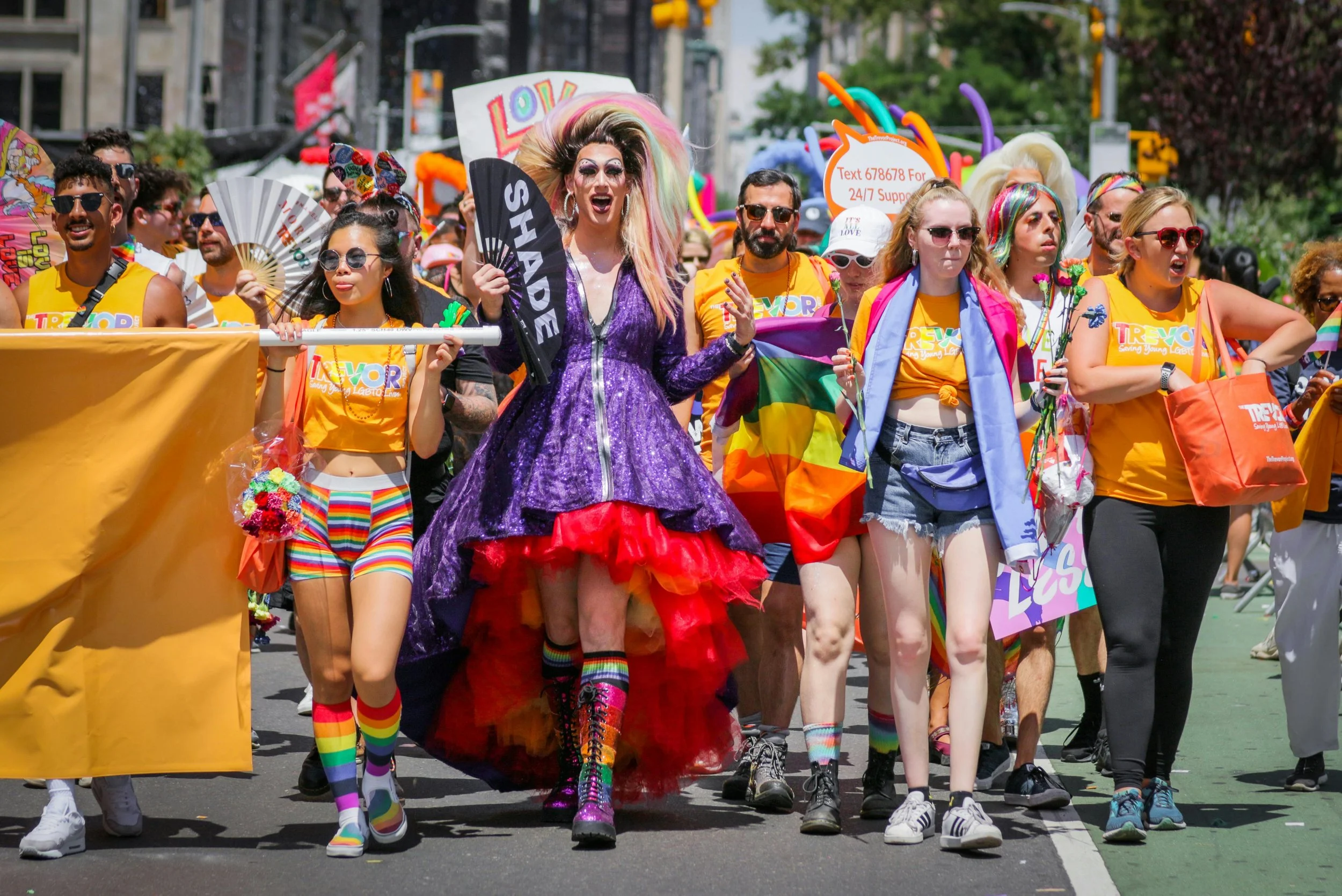 People marching at a pride parade celebrating LGBTQ