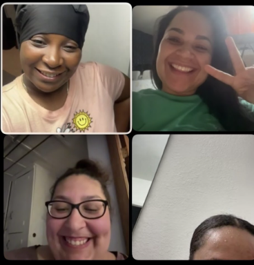 Four women smiling and posing for a video call, three of them showing cheerful expressions, one with glasses, and one making a peace sign.